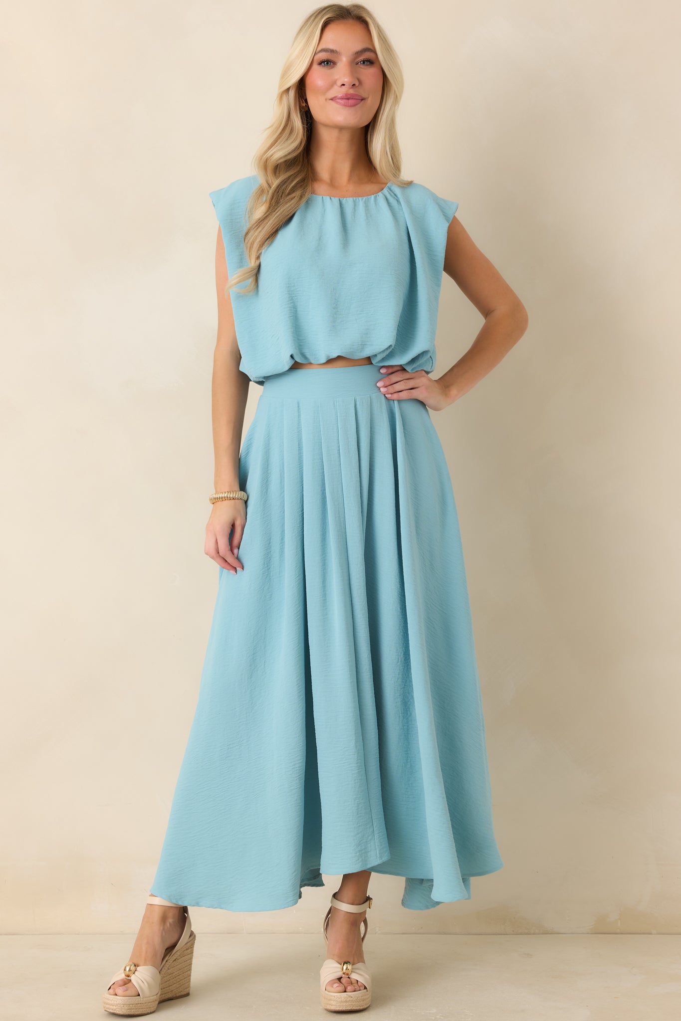 Turquoise maxi skirt featuring a flowy silhouette, elastic waistband, and graceful curved hemline.