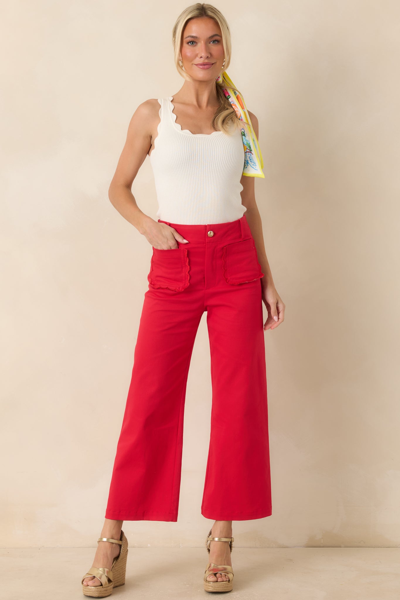 Cherry red high-rise pants featuring a wide-leg cropped silhouette and oversized scalloped front patch pockets.