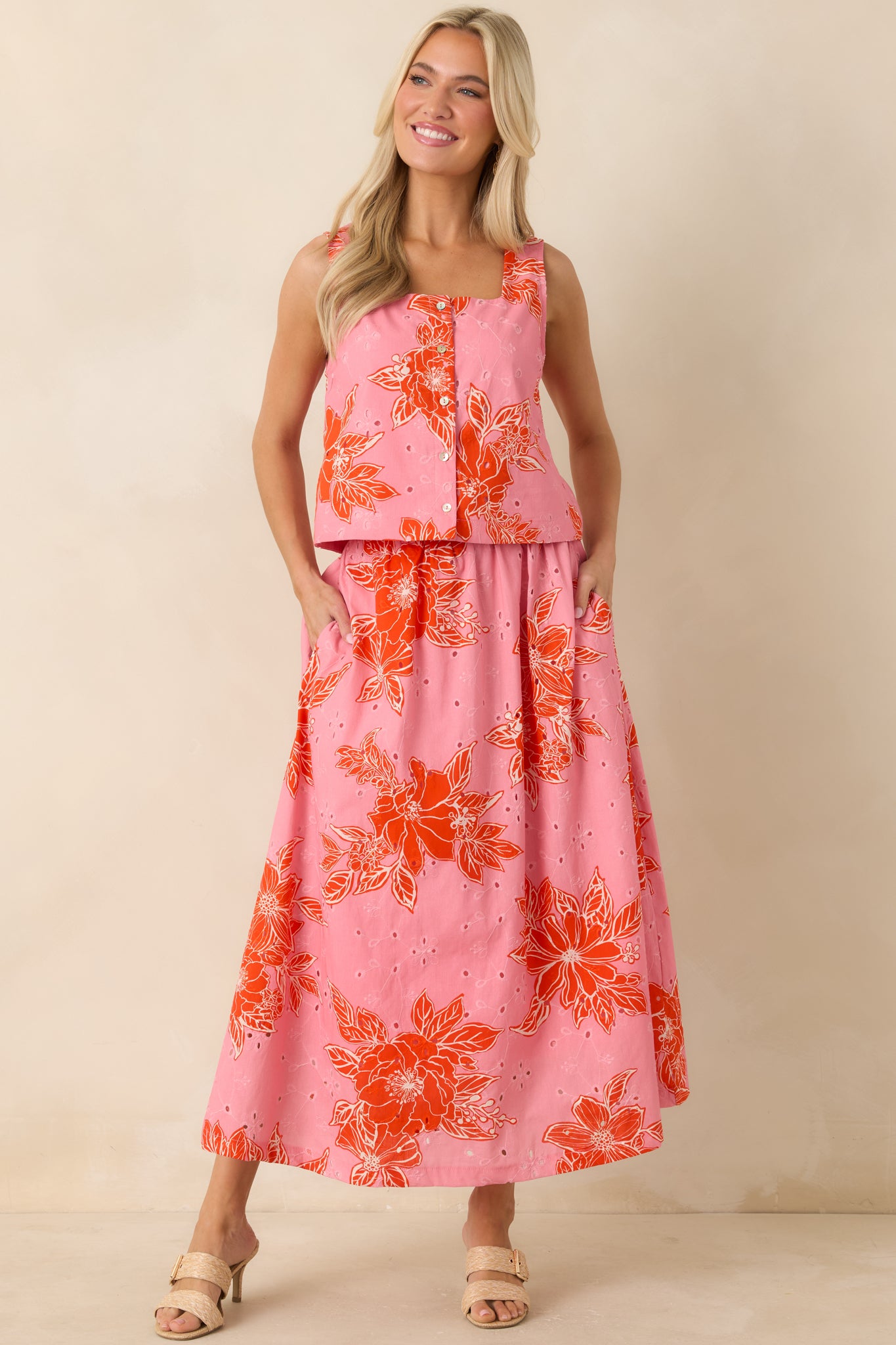 Lightweight floral midi skirt featuring side pockets and breathable eyelet fabric.