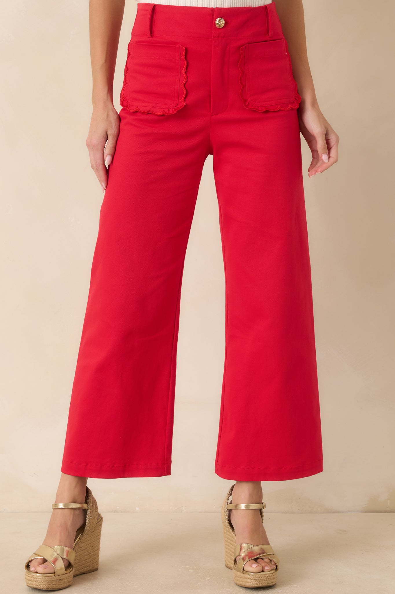 Cropped view highlighting the structured seam work and wide-leg cropped hemline of the pants.