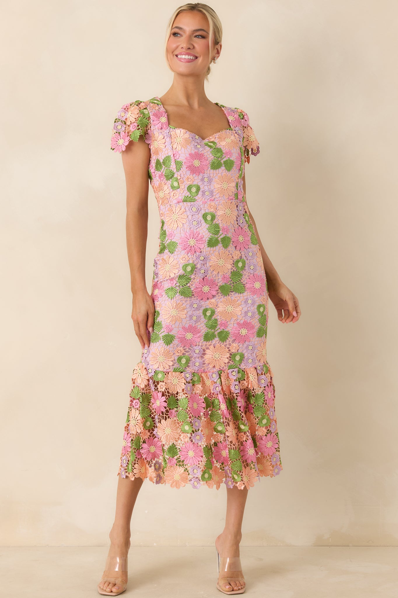 Floral embroidery dress with cap sleeves and a fitted design creating a refined silhouette.