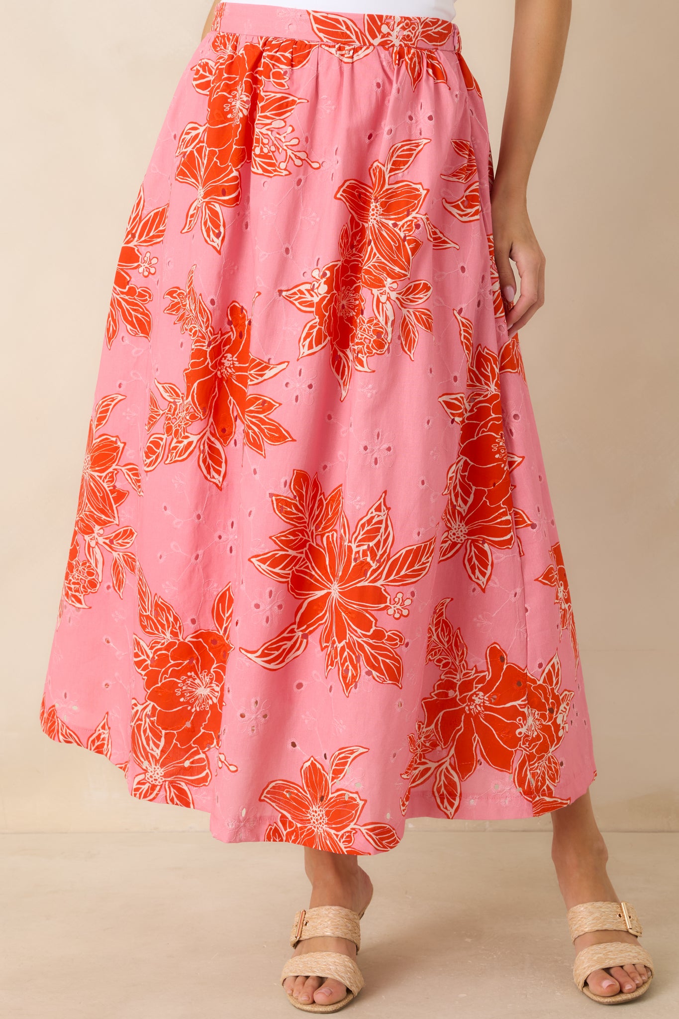 Close view of elasticized waistband on floral eyelet midi skirt with gathered detail.