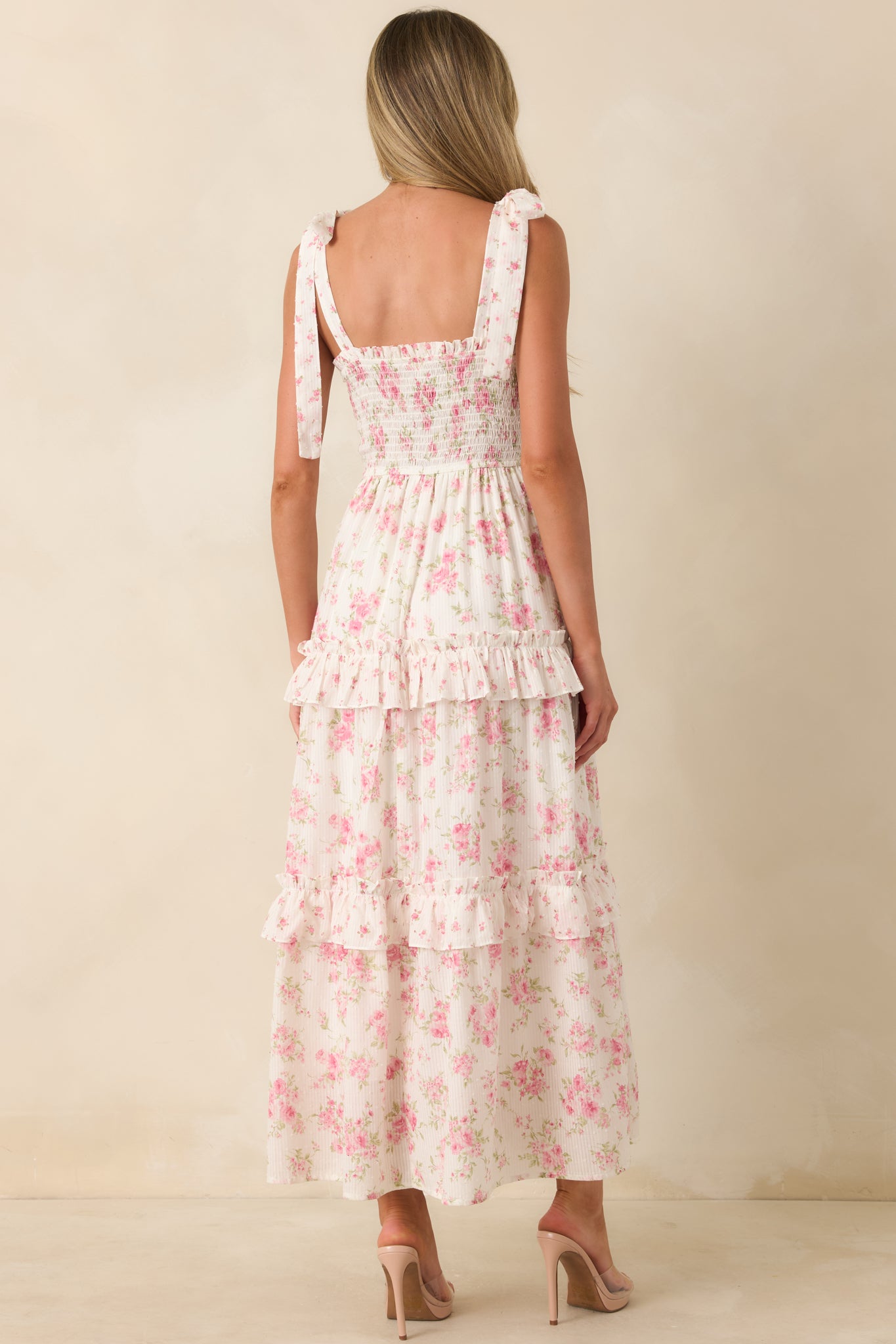 Rear view of the floral maxi dress featuring the softly smocked bodice, flowing tiered ruffle skirt, lightweight cotton fabric, and tie shoulder straps.