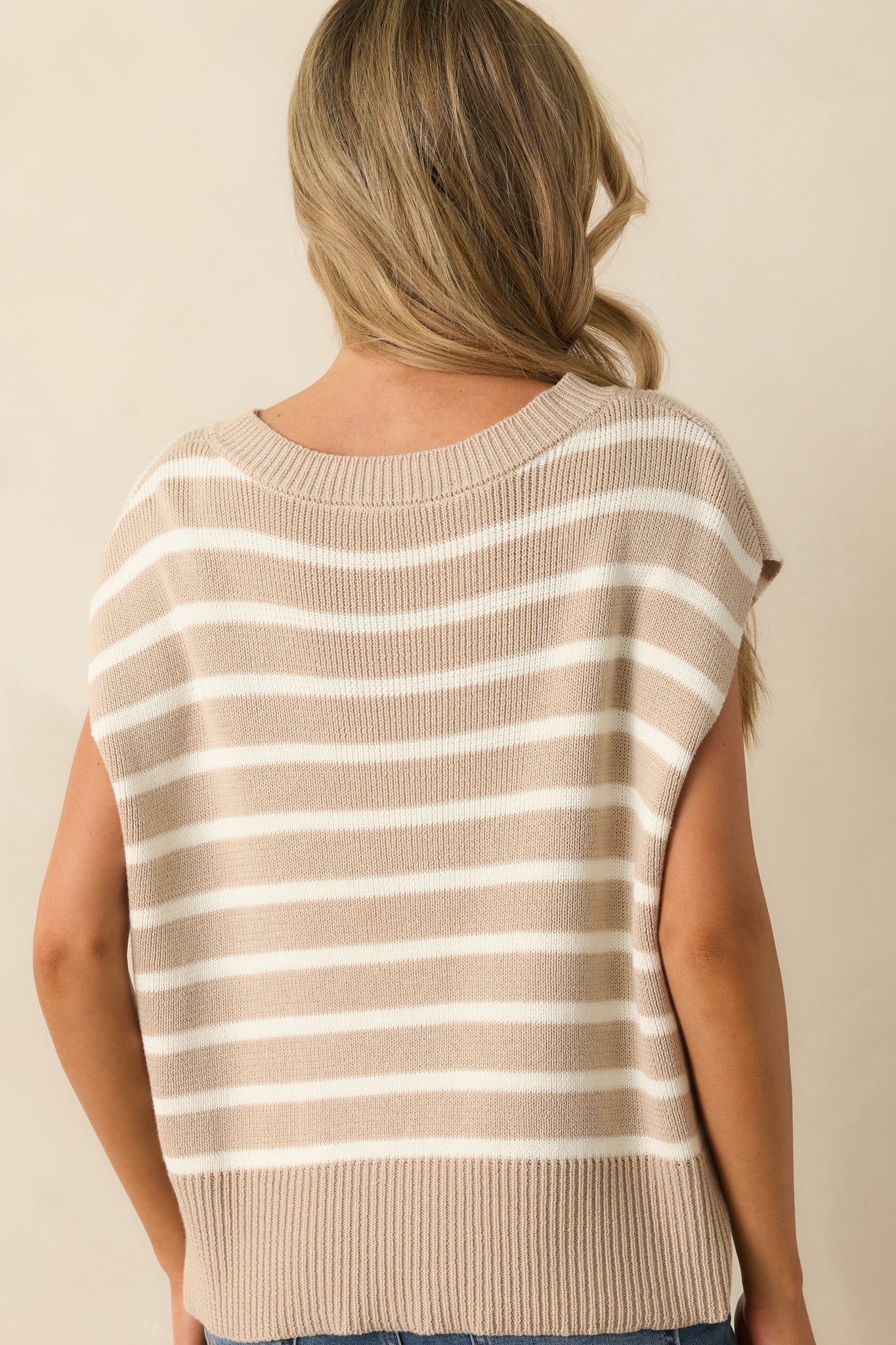 View from behind of the taupe vest, showing the oversized fit, cap sleeves, and horizontal stripe pattern.