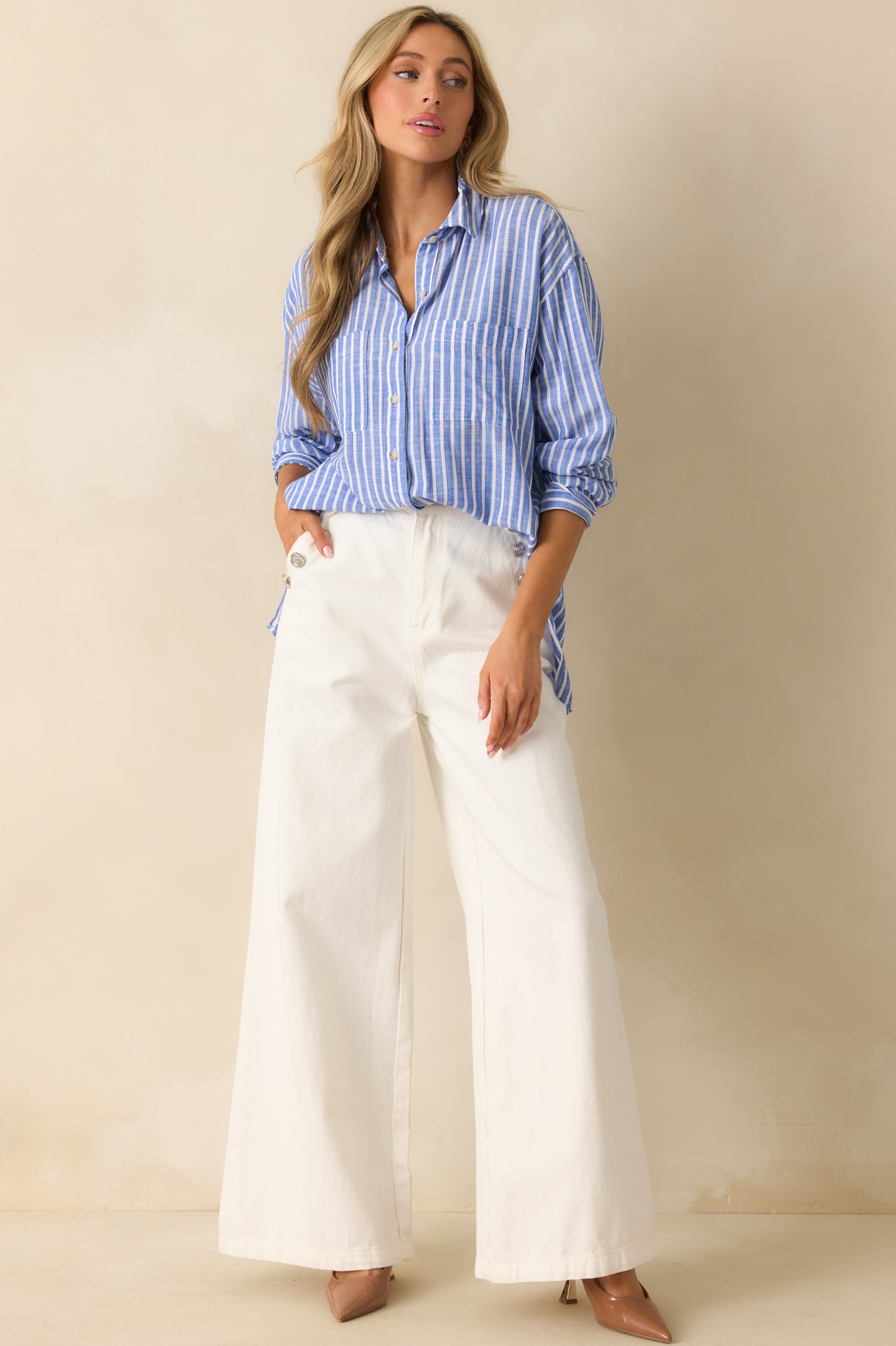 Blue striped top with a collared neckline and vertical stripe pattern.