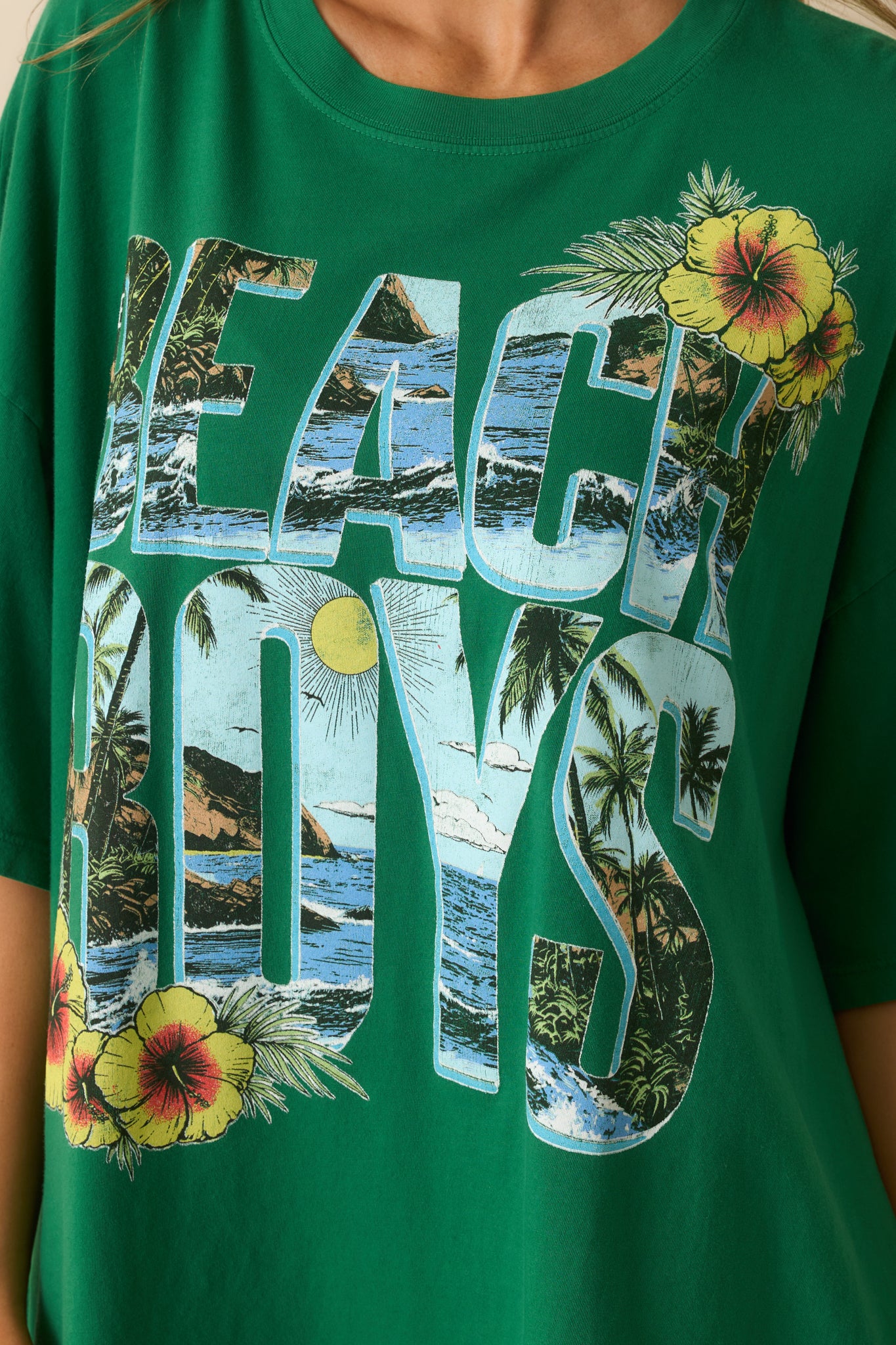 Close-up detail of the tee’s front graphic showing the "Beach Boys" lettering and tropical accents.