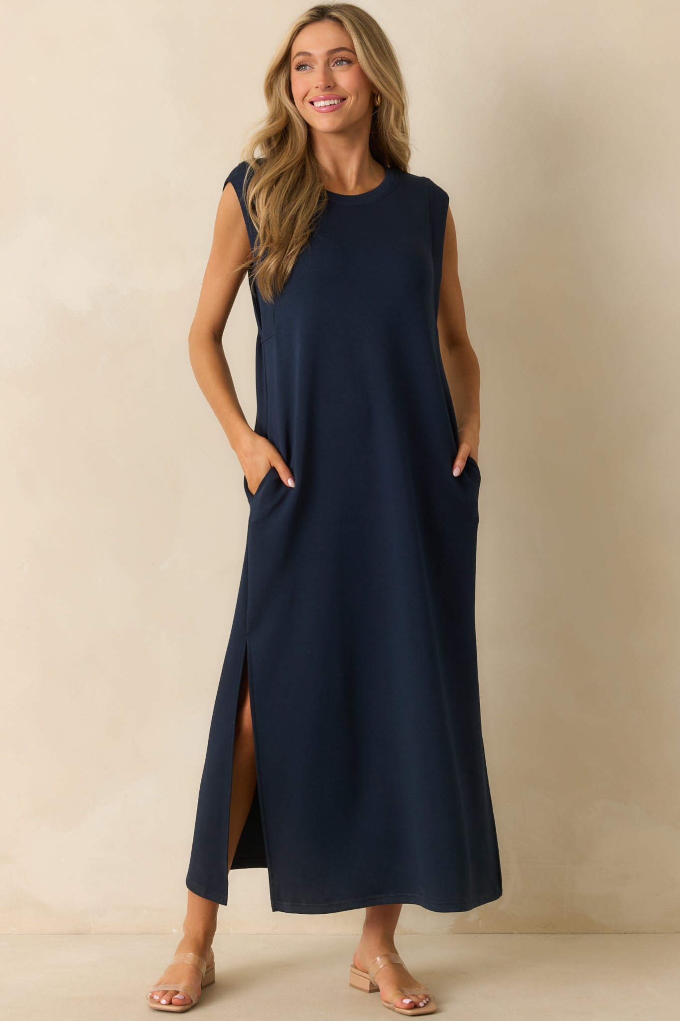Relaxed-fit navy dress with cap sleeves and functional pockets subtly incorporated.