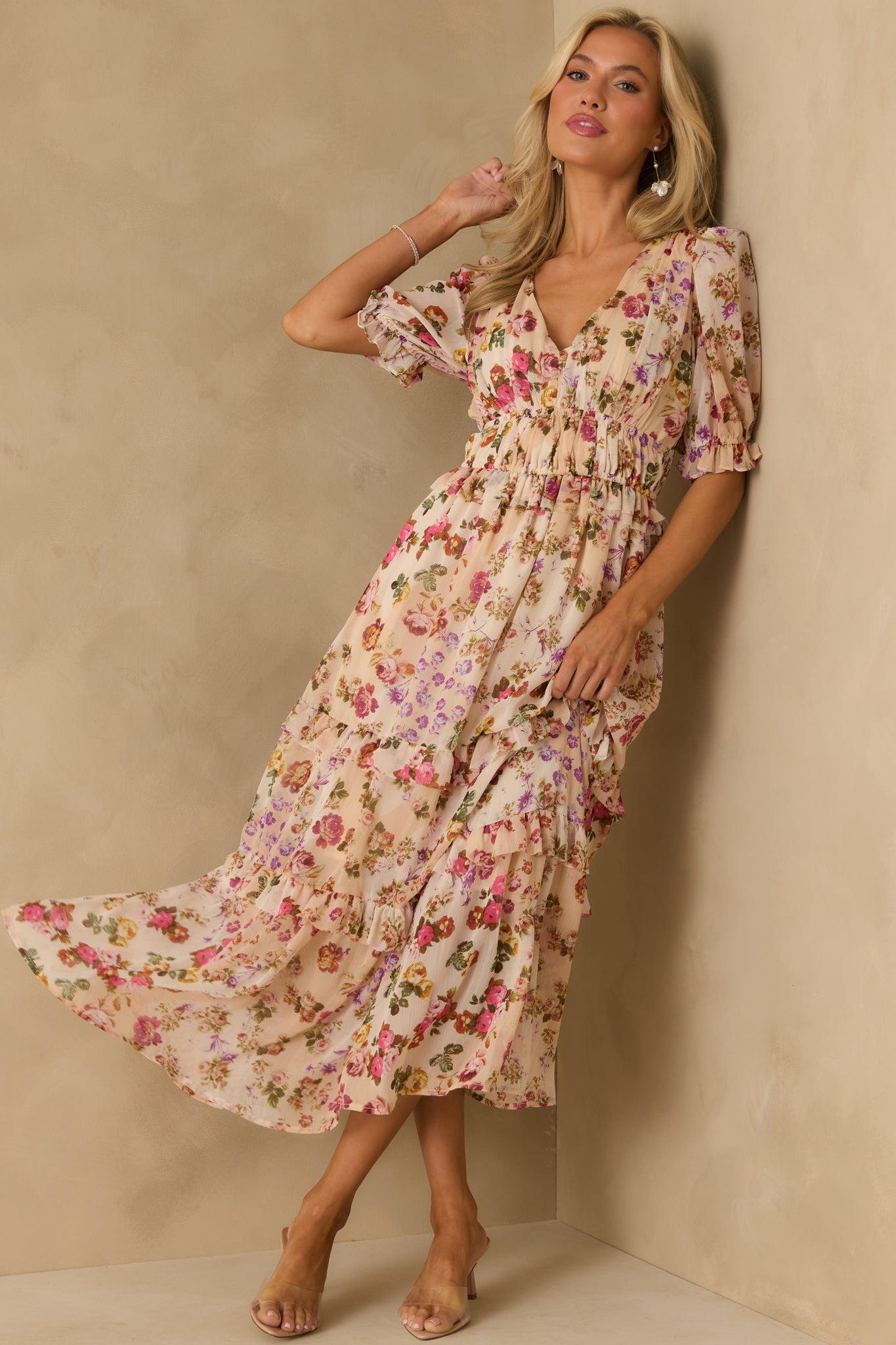 Beige floral midi dress with a v-neckline and puff sleeves, finished with layered ruffle tiers for a soft flow