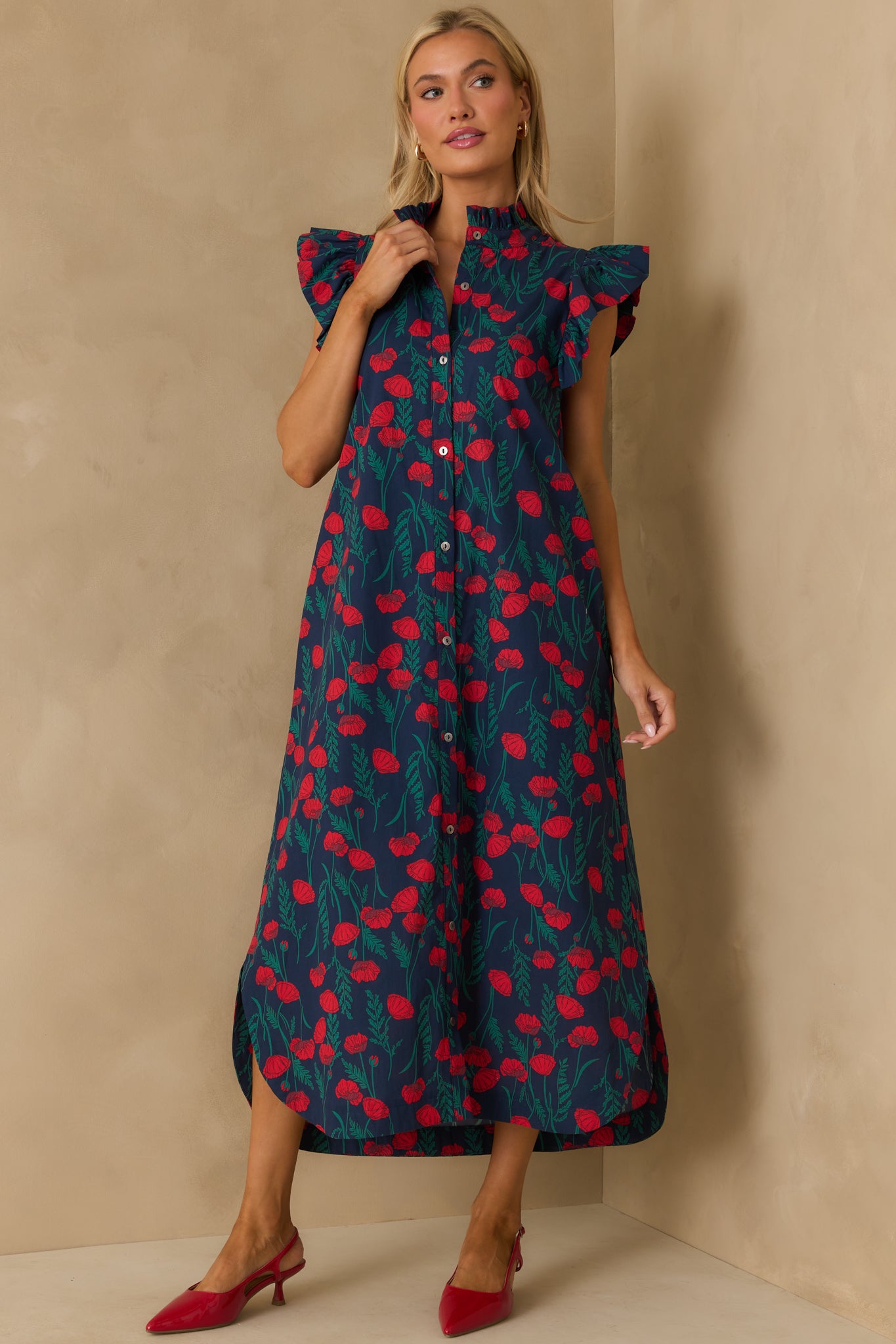 Maxi dress styled with a ruffled neckline, floral print, and practical pockets.