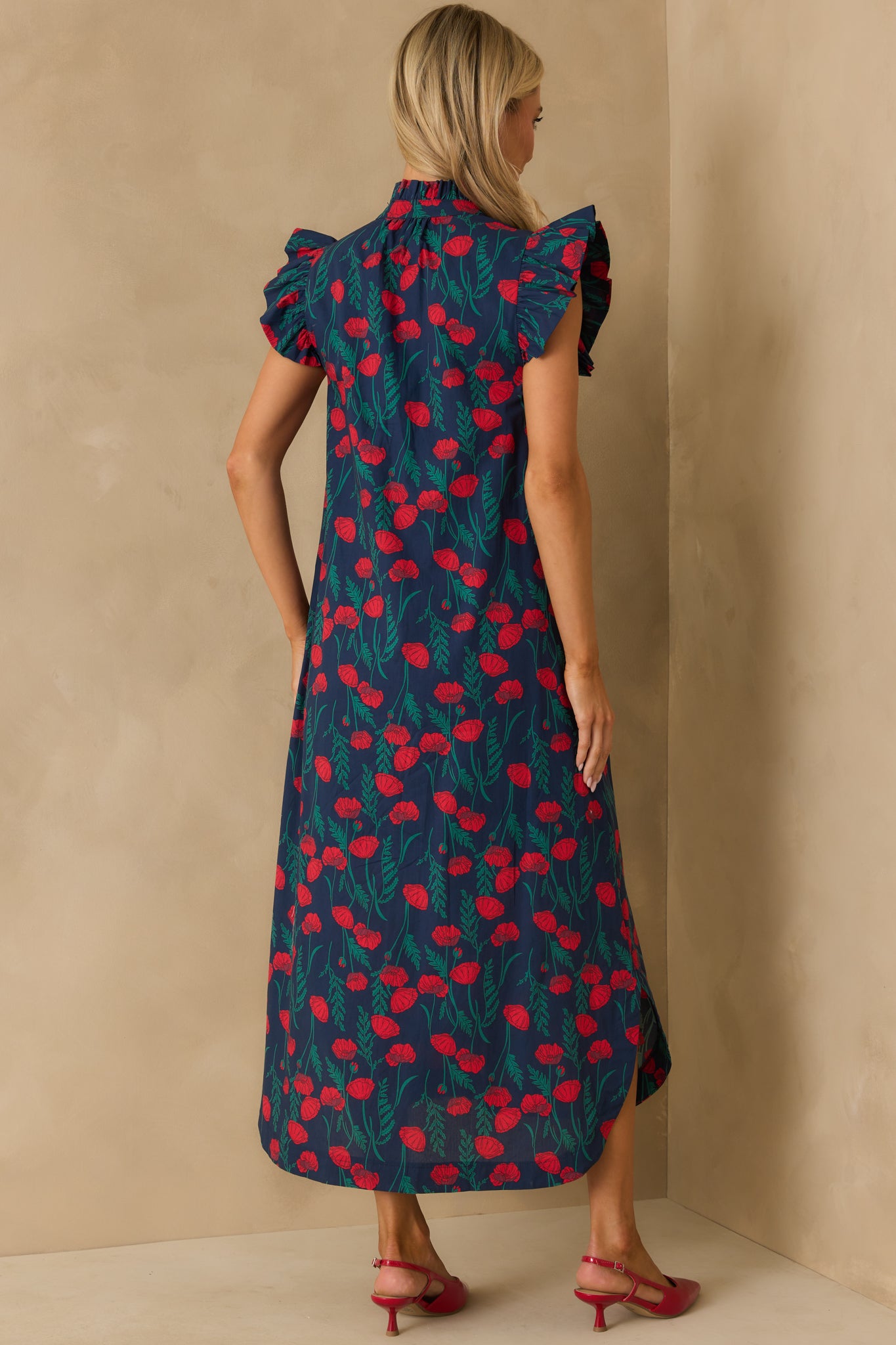 Rear view of the navy maxi dress with flutter sleeves and allover floral print.