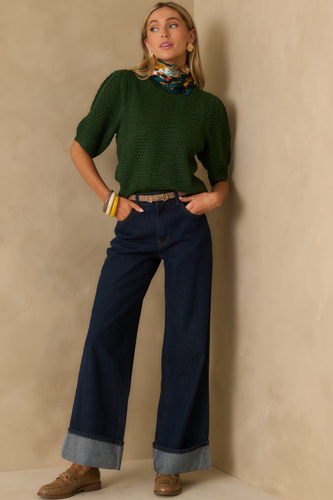 Full body front-facing view showing the crew neckline, ribbed hem, and the mixed knit textures of the sweater.