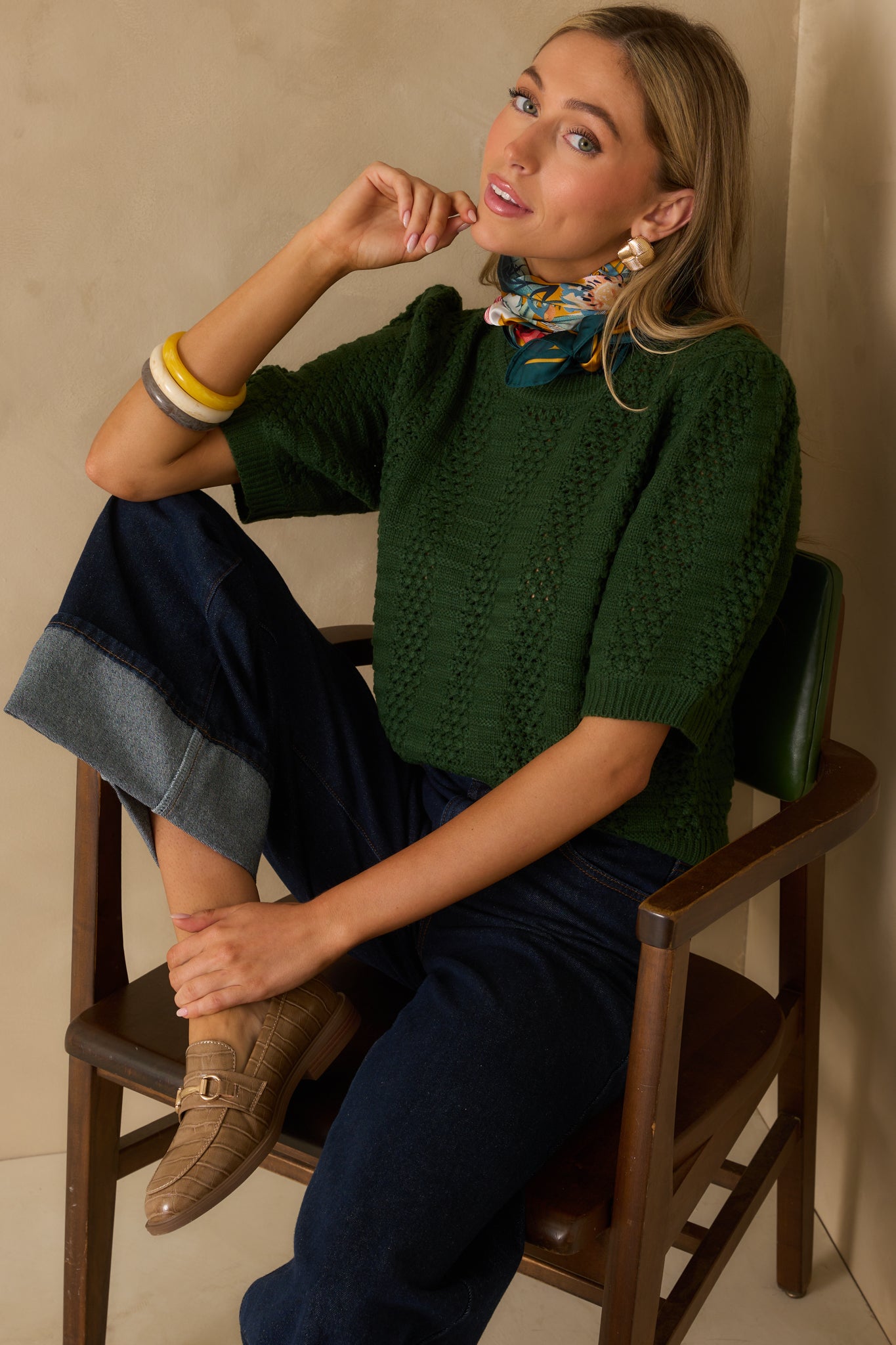 Cropped view of the lower hem area displaying the ribbed hemline and the continuation of the alternating knit panels.