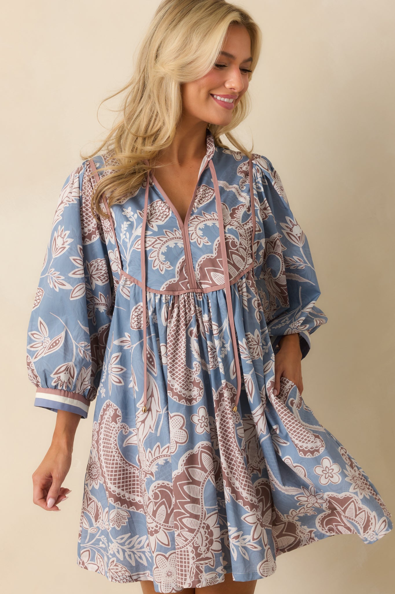 Focused midsection view, emphasizing the functional pockets and floral paisley pattern.