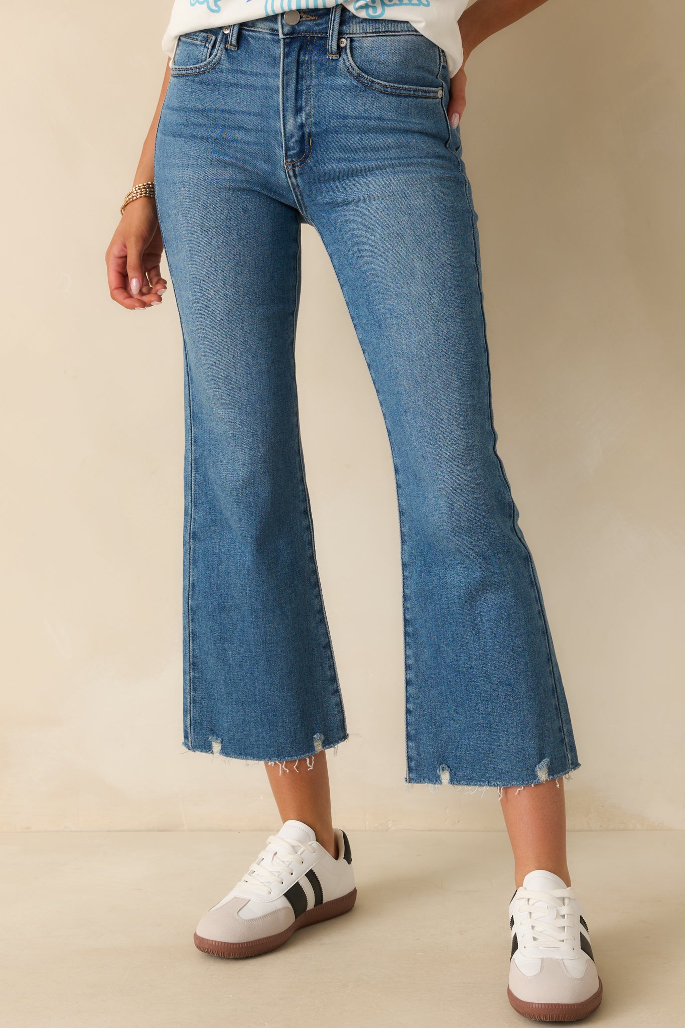 Cropped shot of the waistband showing the button and zipper closure with belt loops.