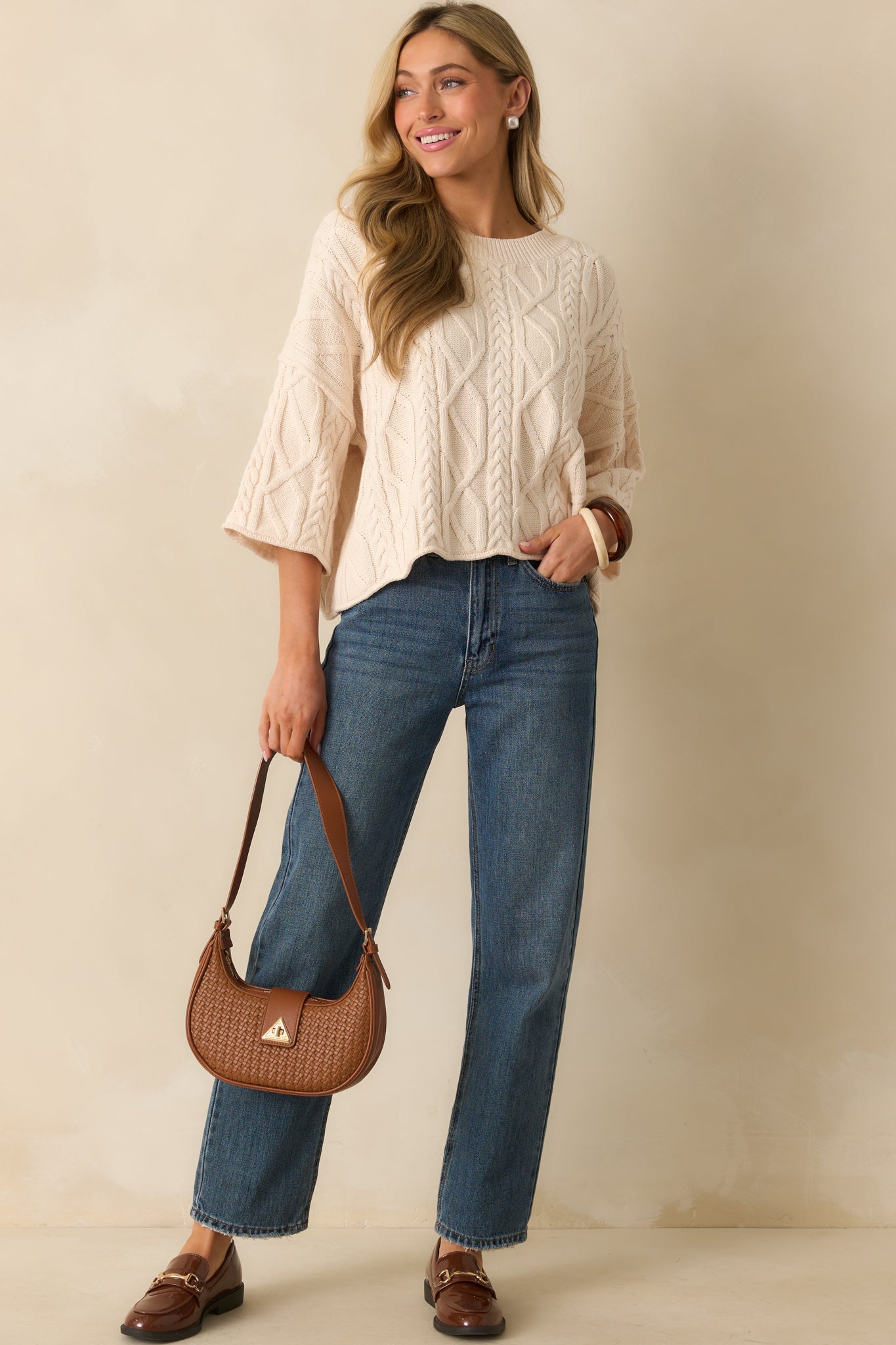 An angled full body shot emphasizing the textured knit design and casual silhouette.