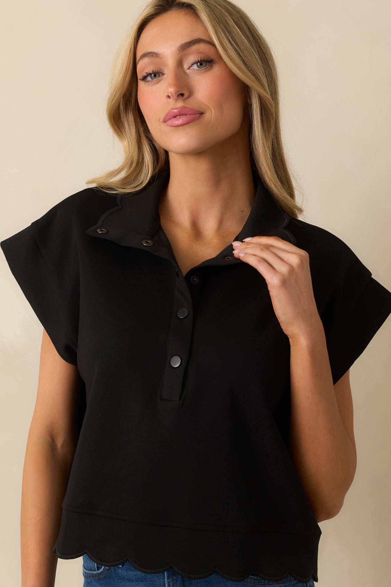 Front-facing photo of a model wearing a pullover sweater with a relaxed fit and soft, draped silhouette.