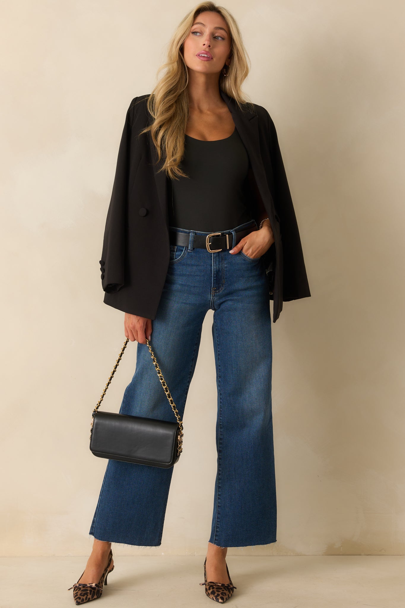 A full front view of the dark wash jeans featuring a high waist and straight leg cut.