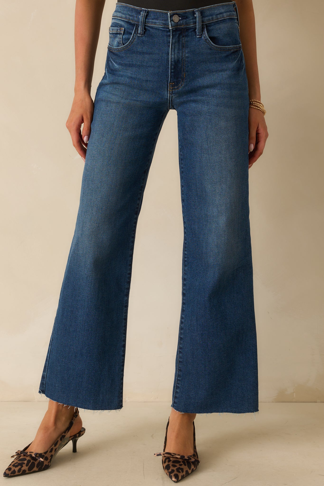 A cropped waist-down view focusing on the high-rise waistband and front pockets.