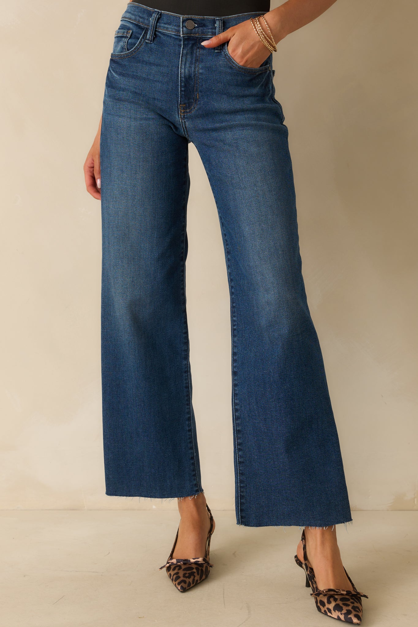 A cropped front view highlighting the zipper and button closure with dark wash detailing.