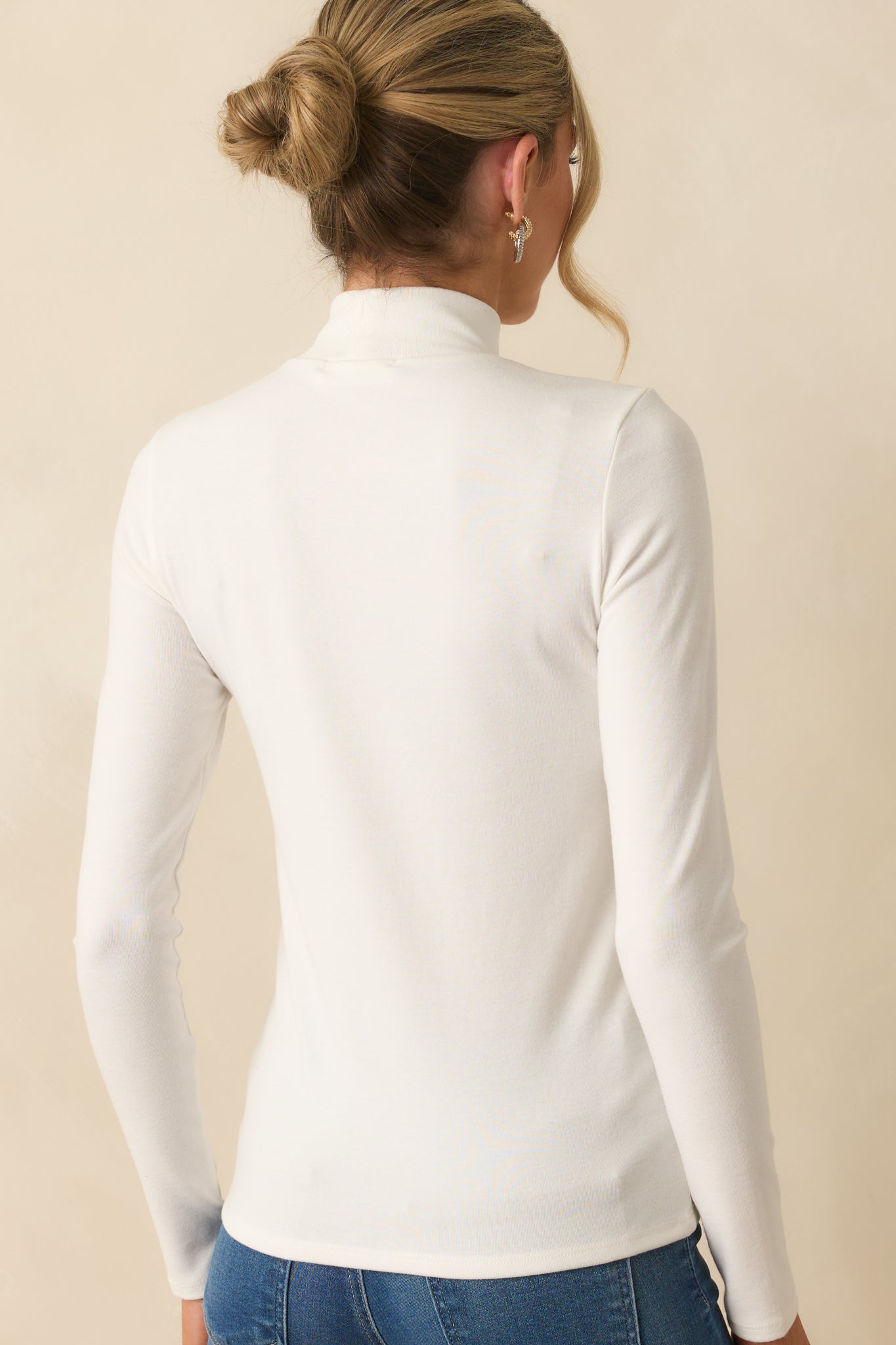 Rear view of long sleeve top showing clean, simple lines and lightweight fabric.