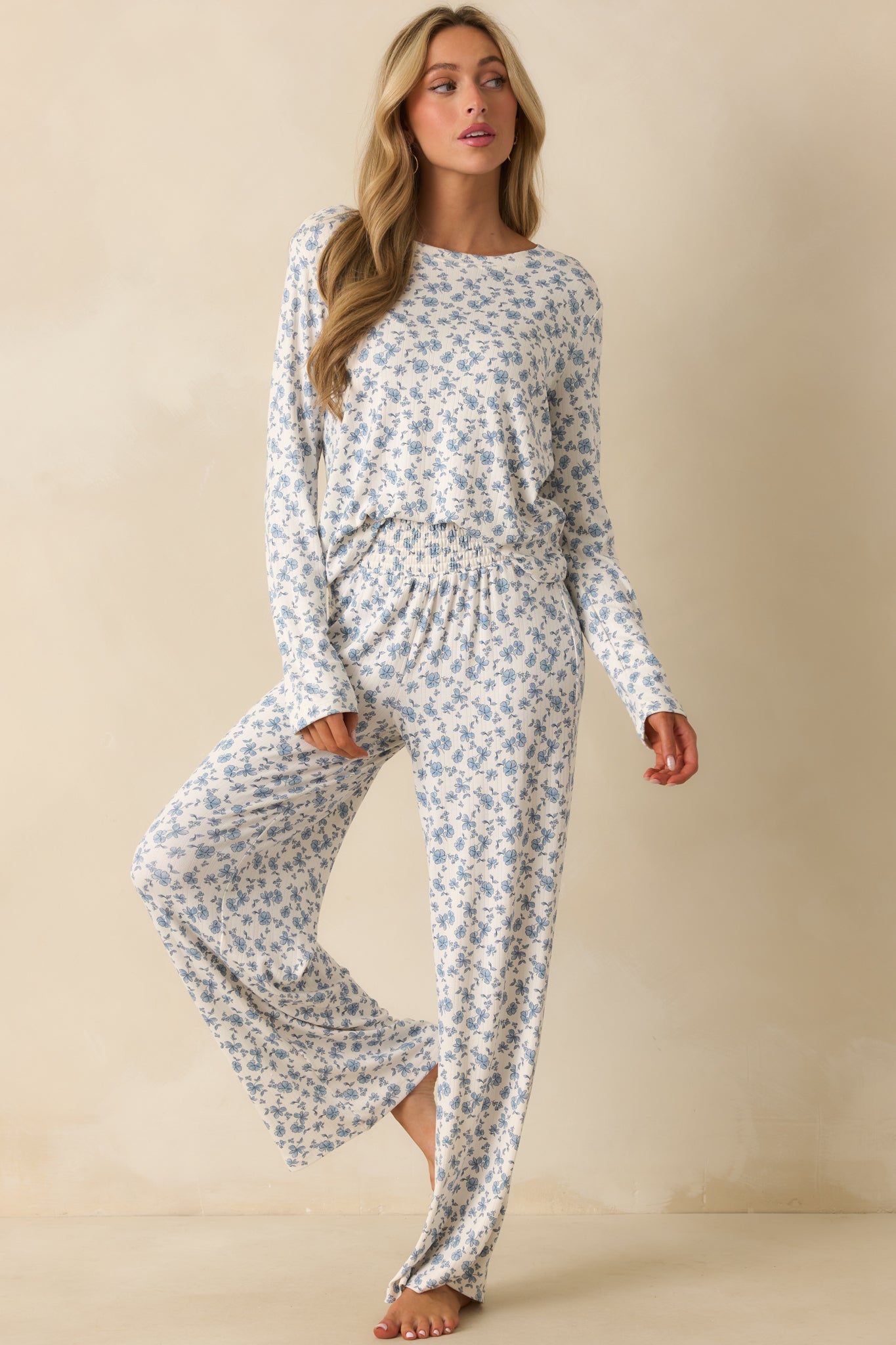 Ivory ribbed knit top with blue floral print, long sleeves, and a relaxed fit.