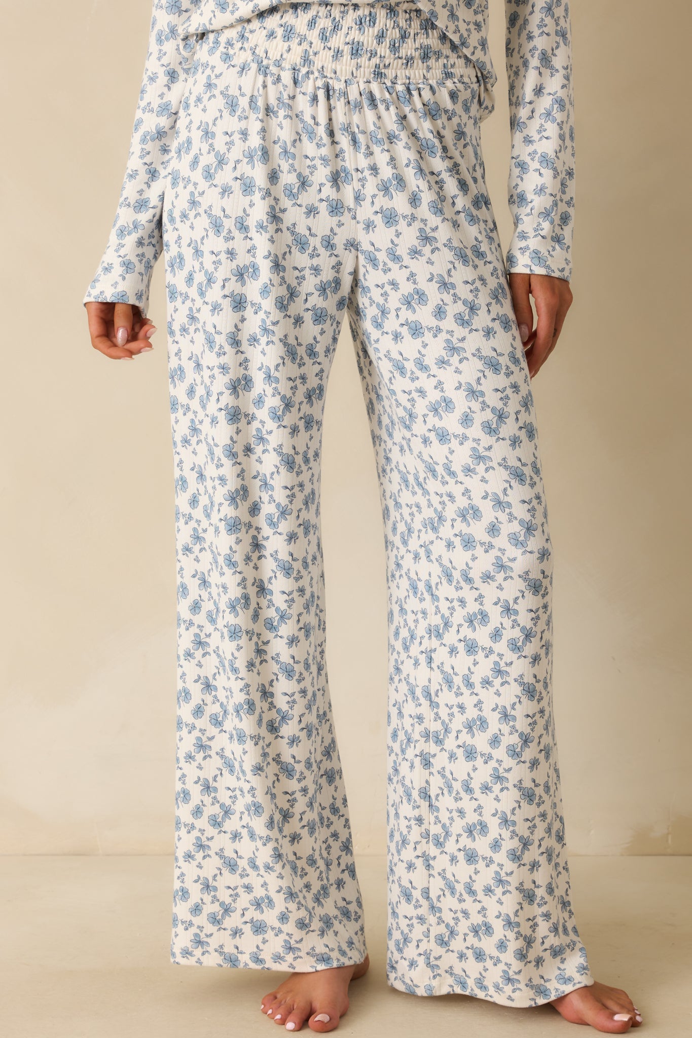 Smocked waistband detail adding texture and comfort to the floral pants.