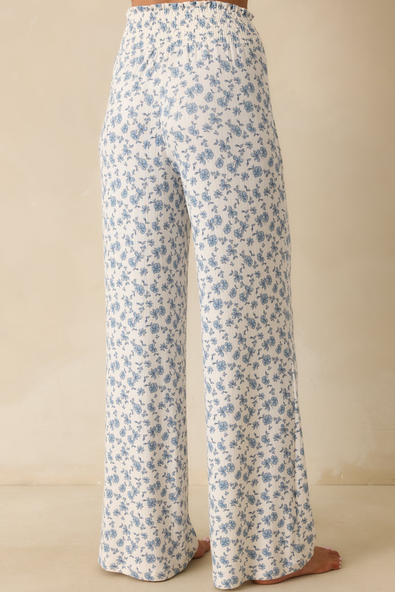 Rear view of wide leg floral pants with smocked waistband and relaxed silhouette.