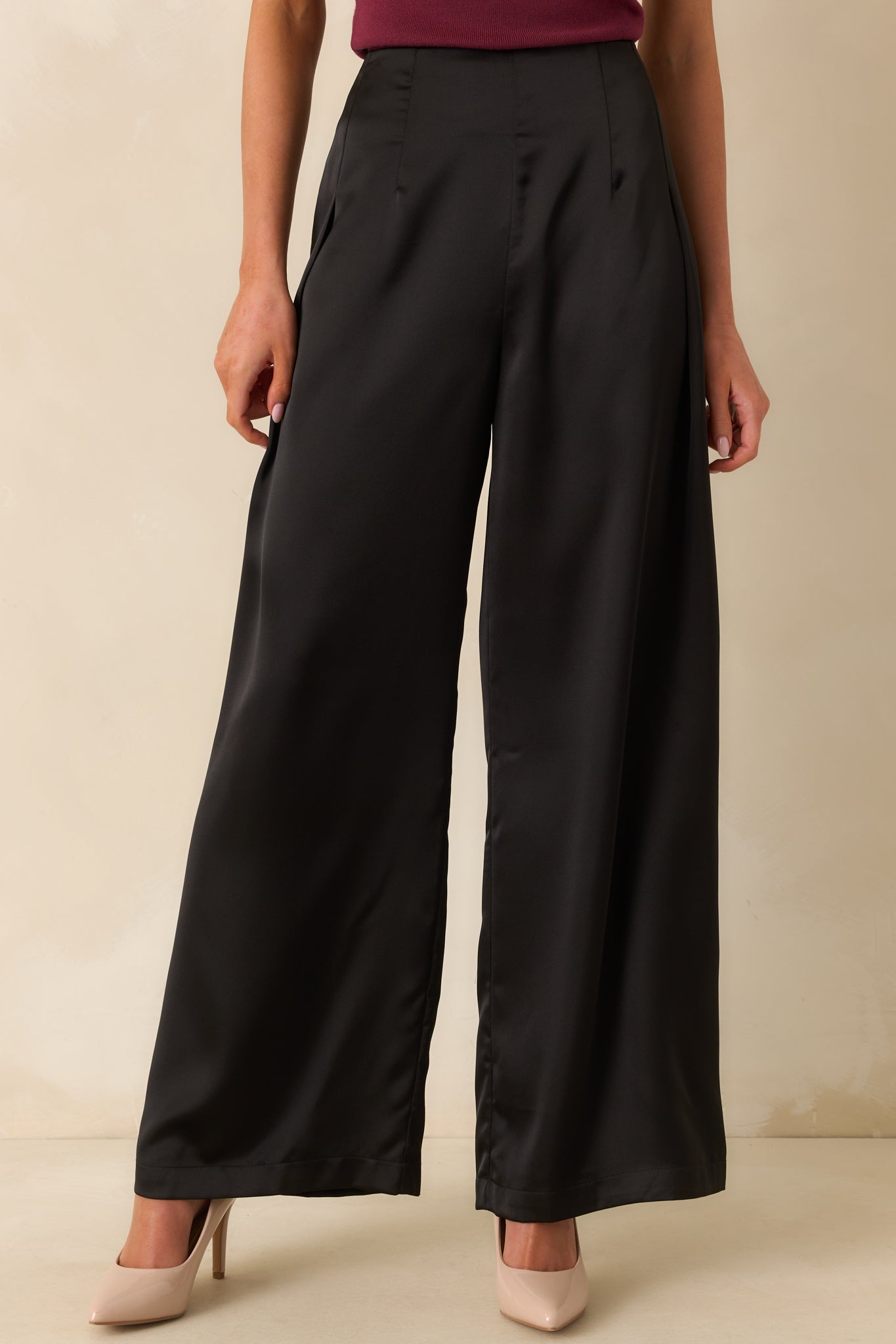 A cropped front view showing a clean hemline and subtle sheen of the satin pants.