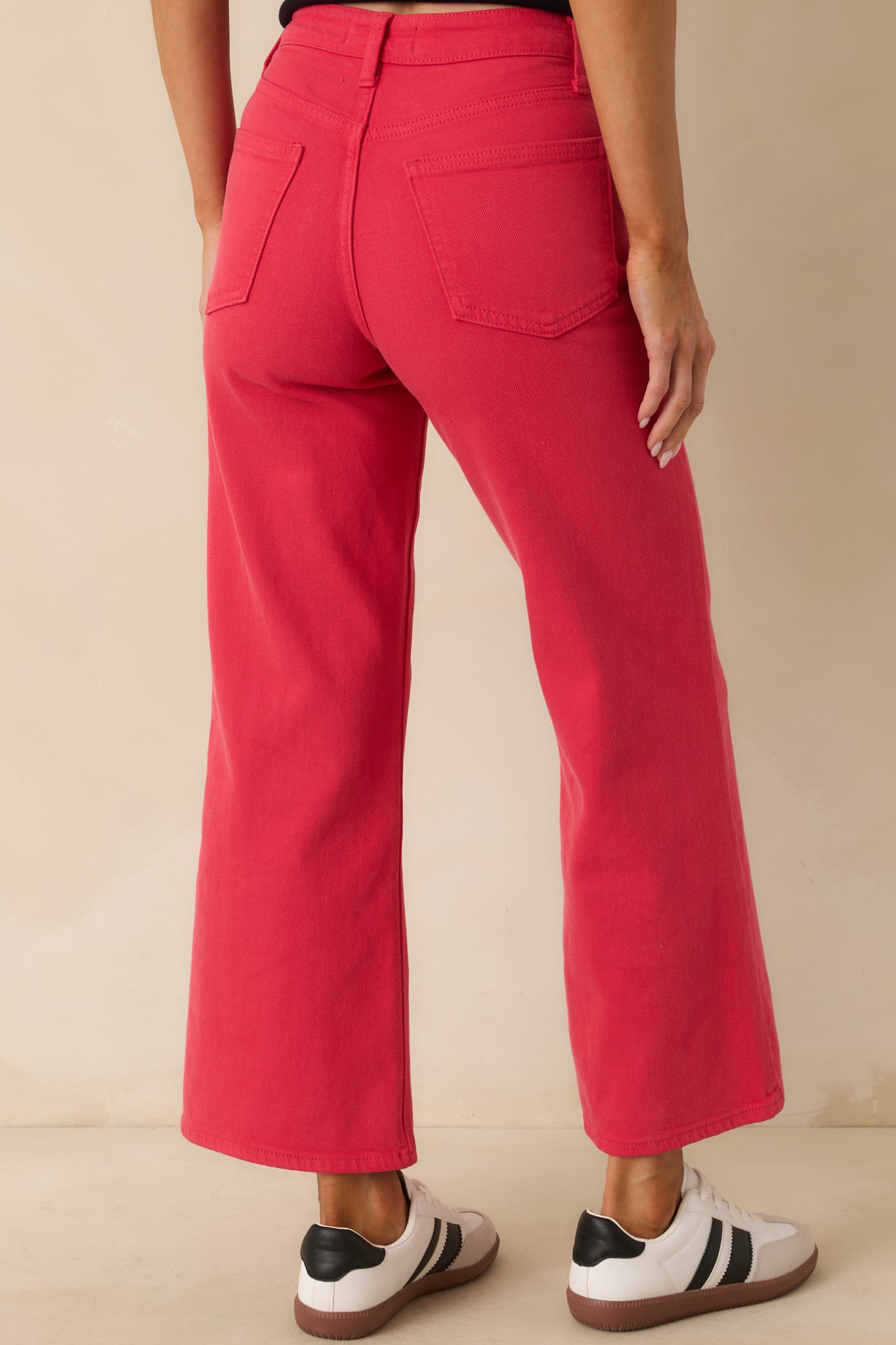 Rear view of the red jeans featuring functional back pockets and high-waist design.
