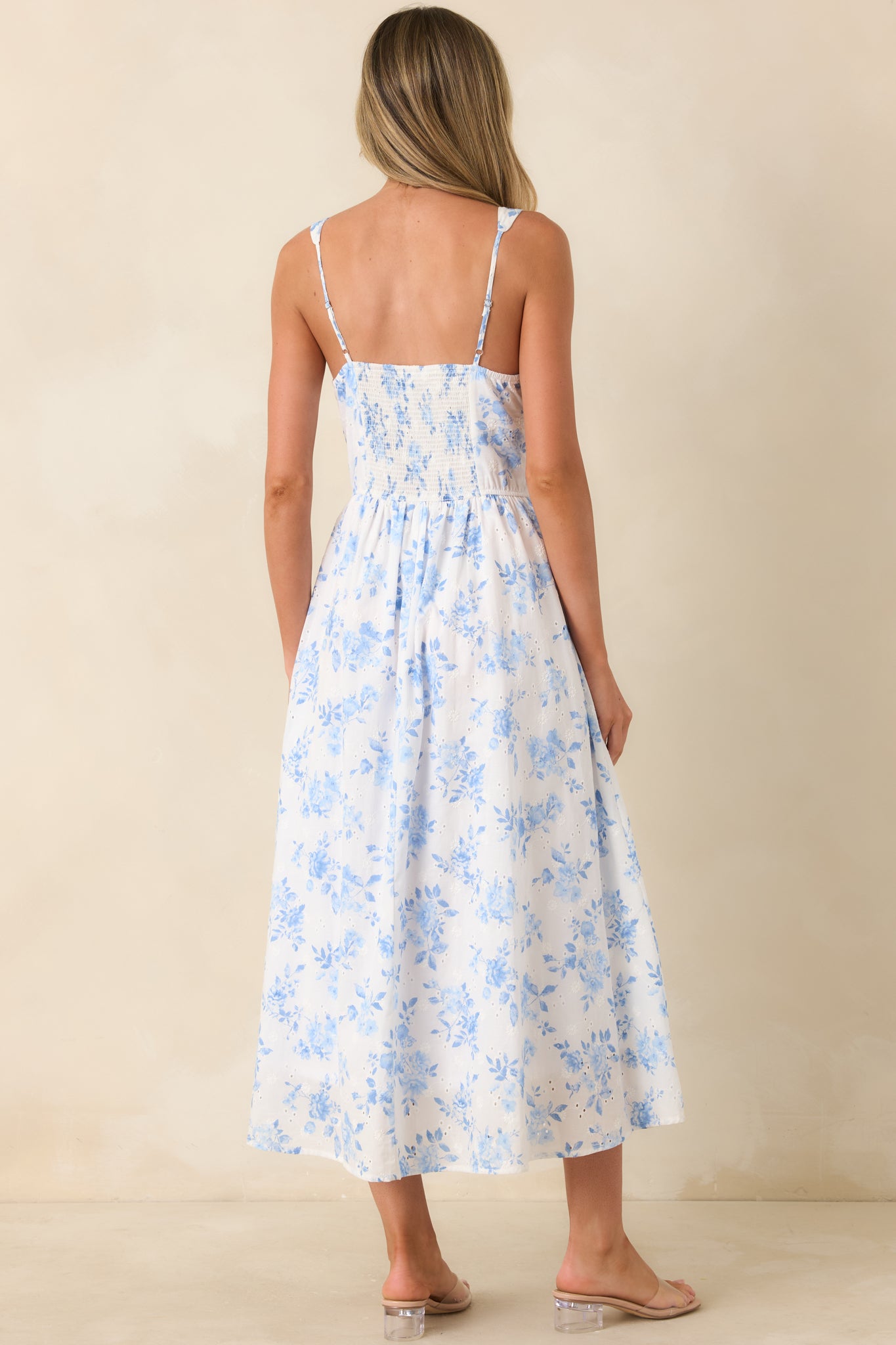 Rear view of peasant-style dress with wide straps and flowing skirt silhouette.