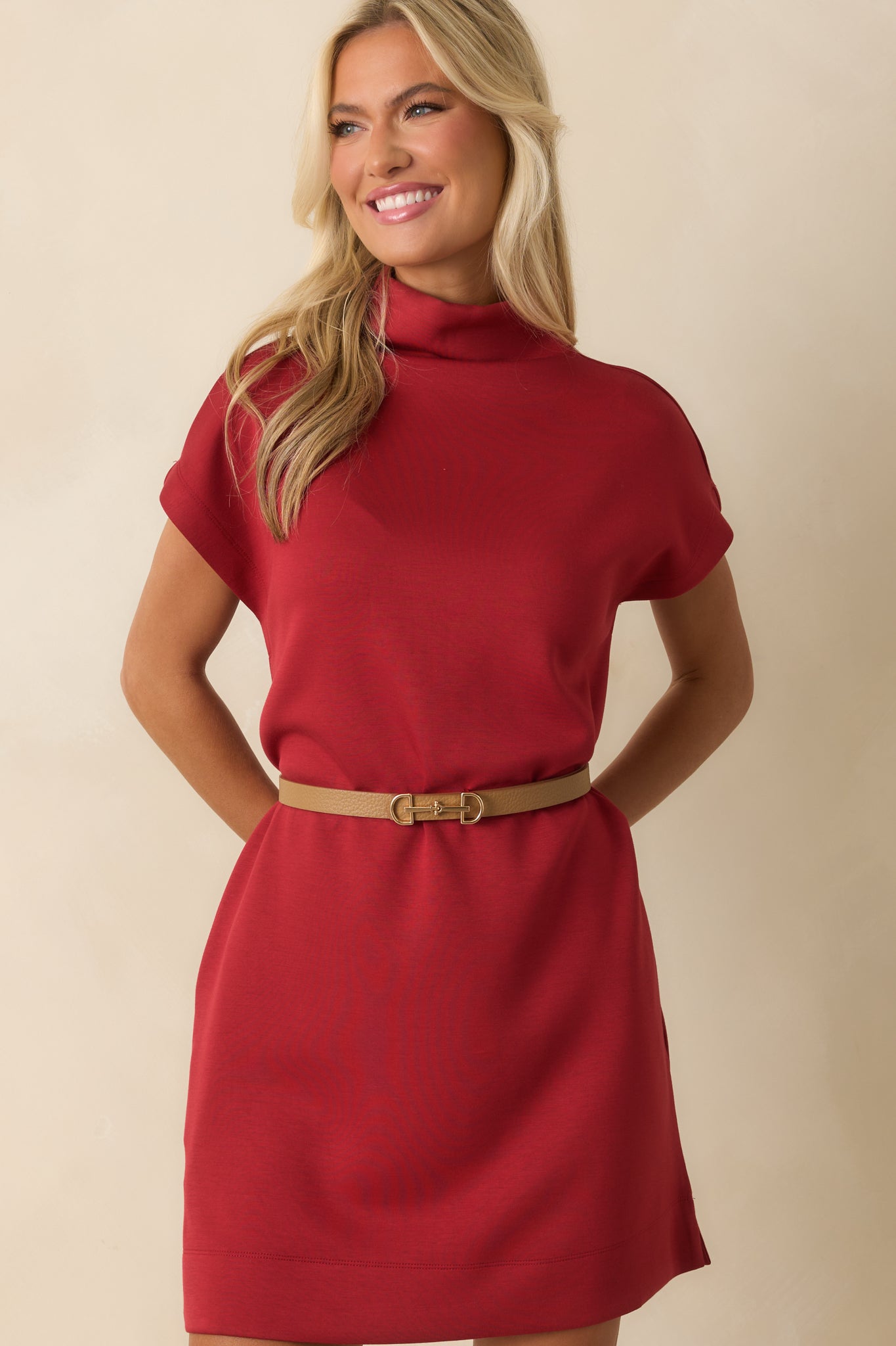 Red dress with a closer view of the mini hemline and relaxed shape.