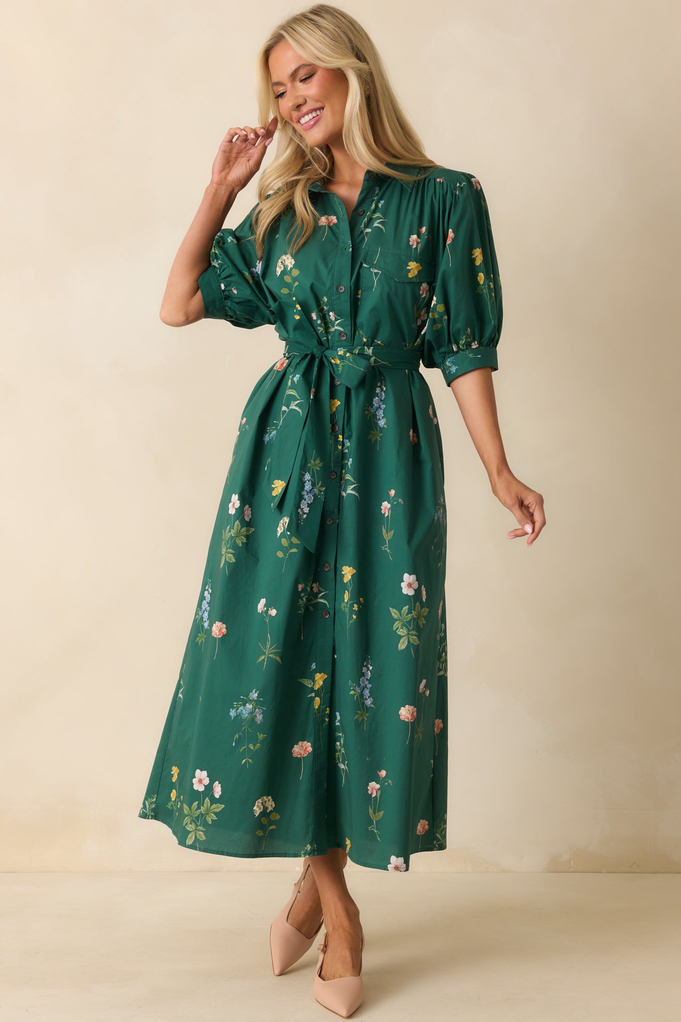 Forest green maxi dress with multicolor floral print, collared neckline, and half-length puff sleeves.