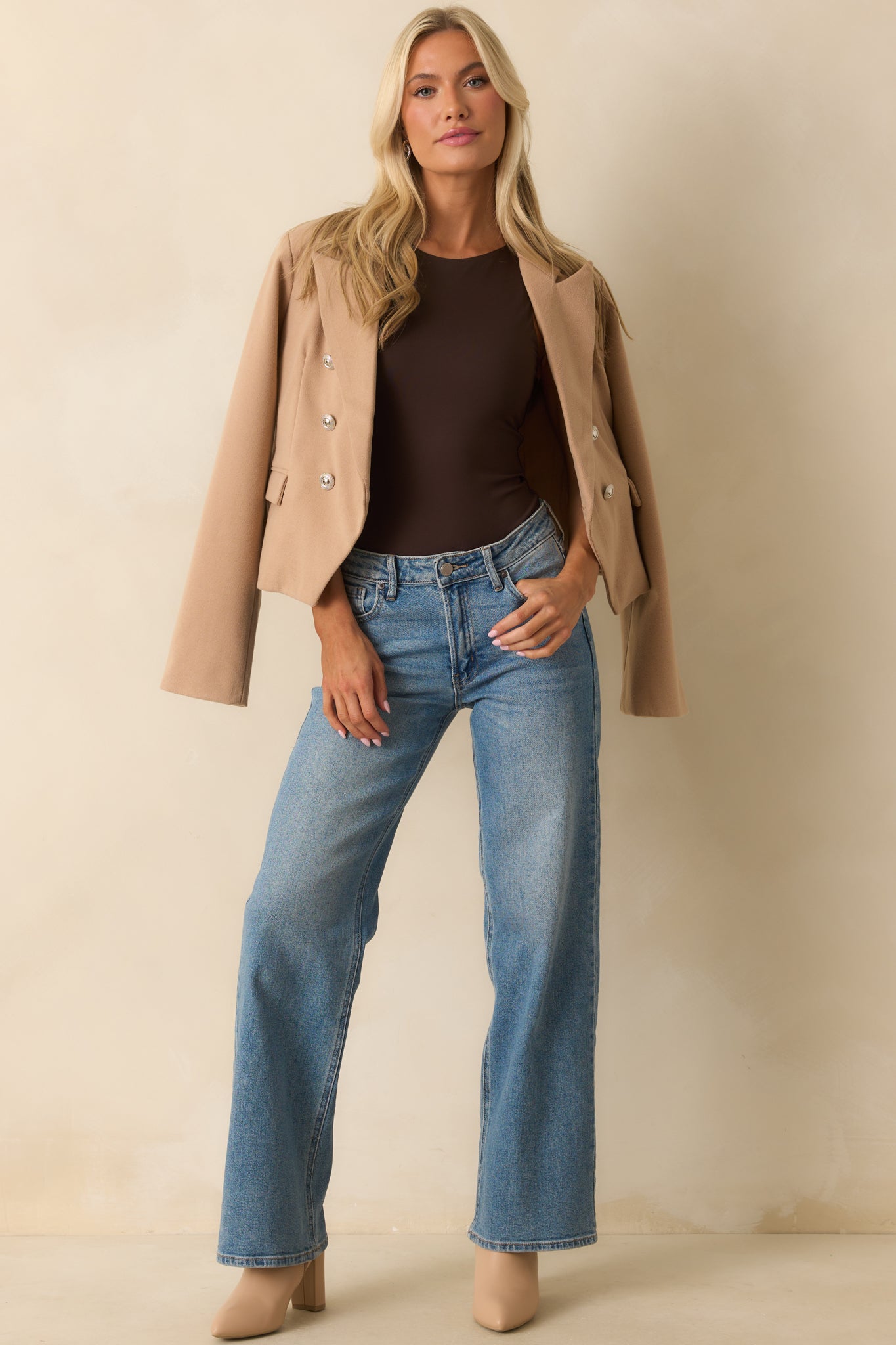 Another full-length shot of the tan blazer emphasizing the silver buttons and overall length.