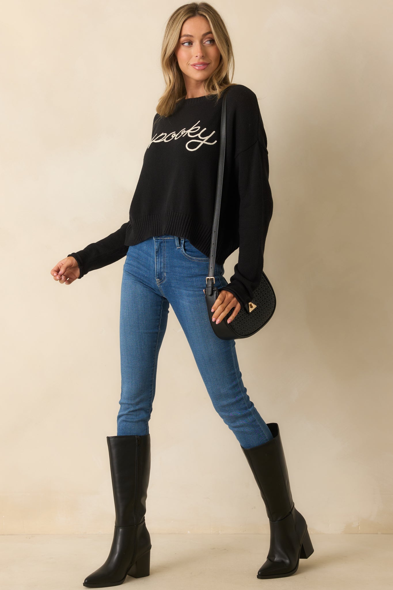 Relaxed black sweater styled with ribbed cuffs and hem for a classic finish.