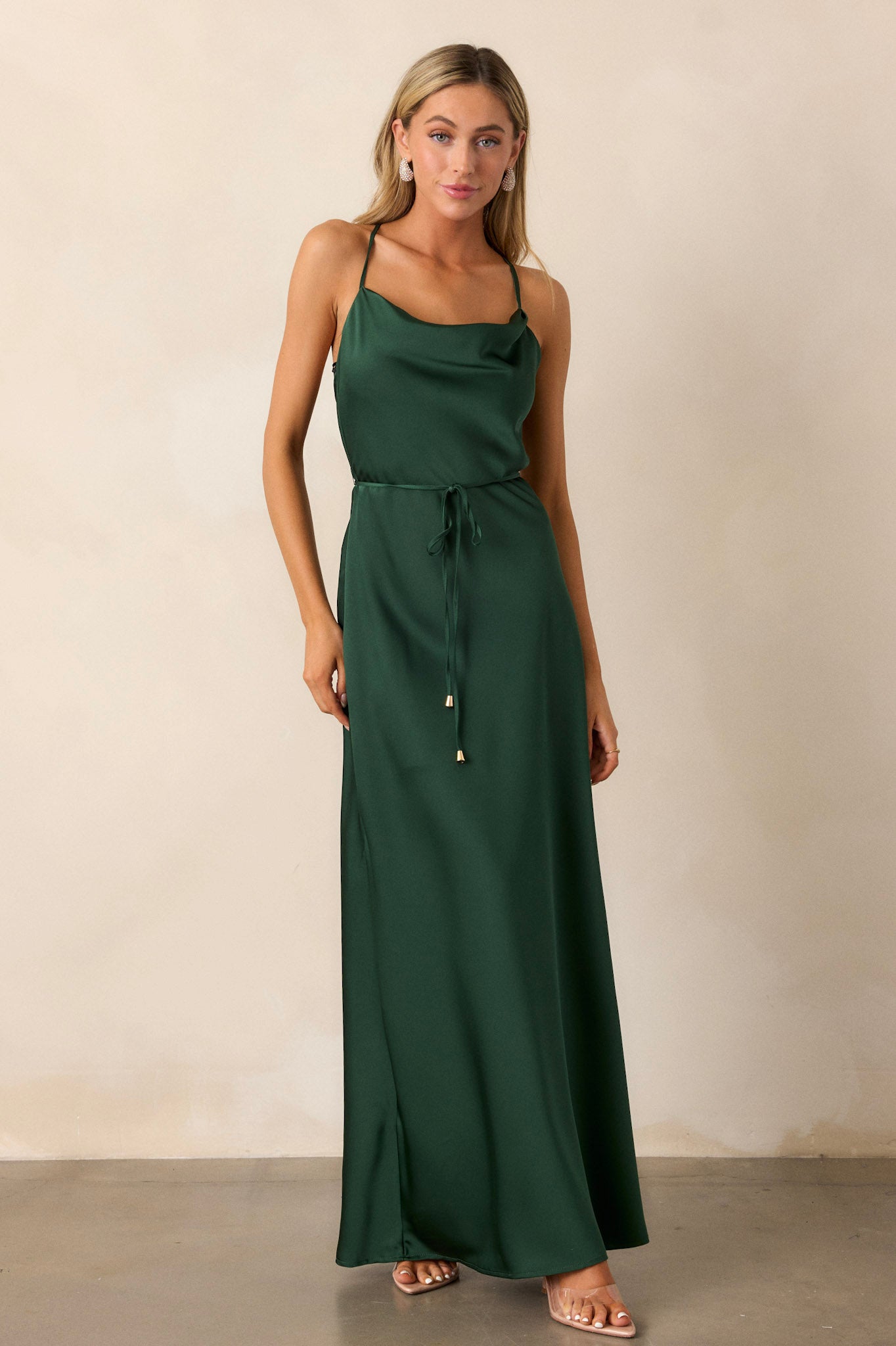 Front image of the emerald dress, showcasing the cowl neckline, adjustable straps, and the soft drape of the satin fabric across the chest.