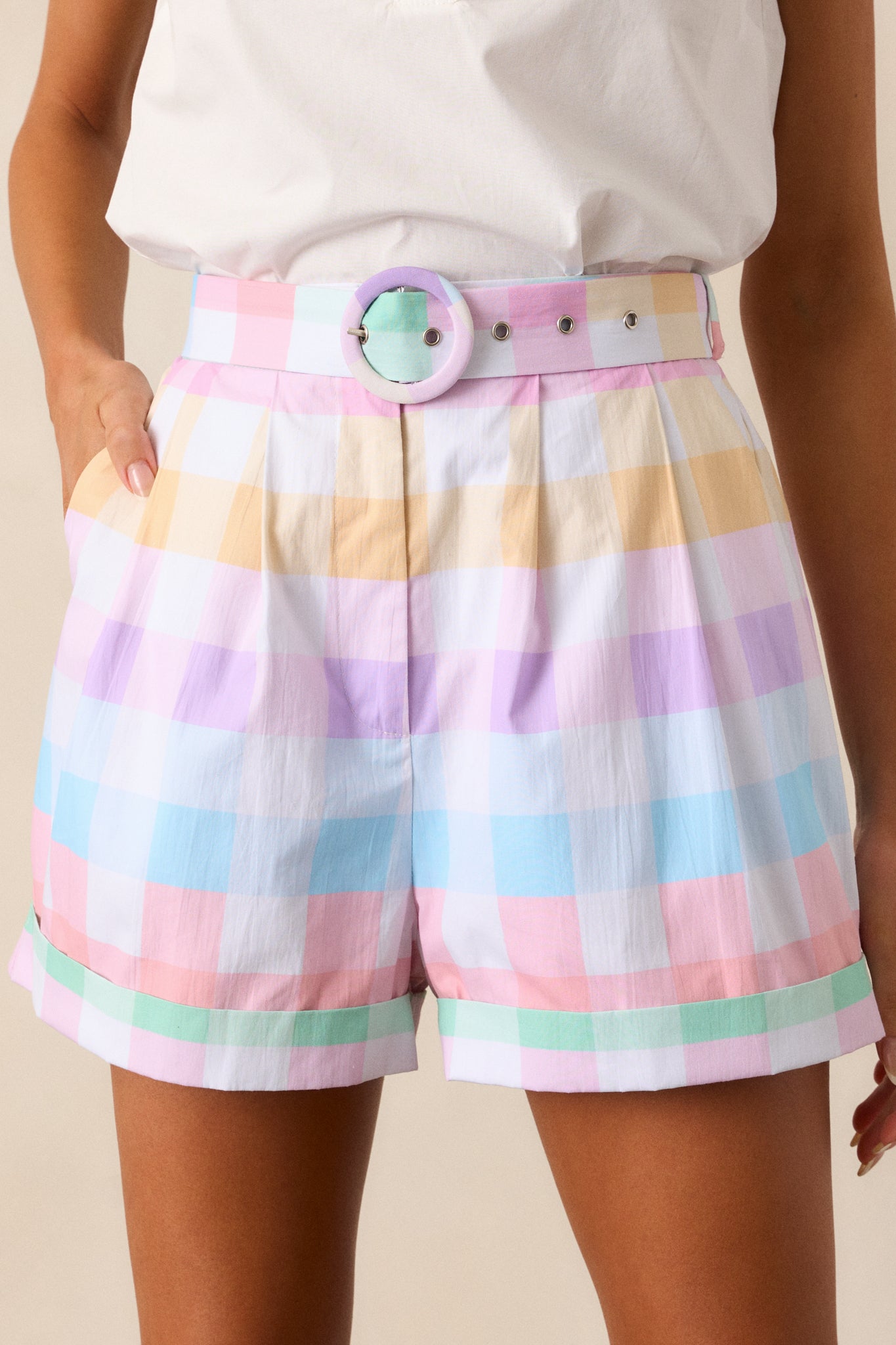 A close-up of the cuffed bottom hems and pleated detailing, highlighting the tailored design of the shorts.