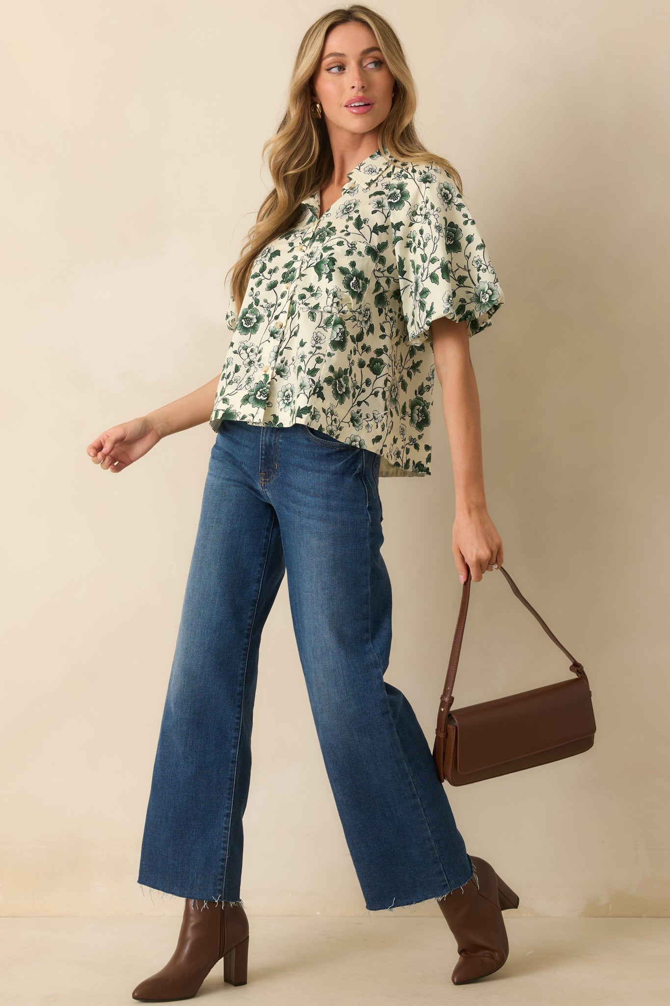 Floral top featuring a functional breast pocket and soft, flowing silhouette