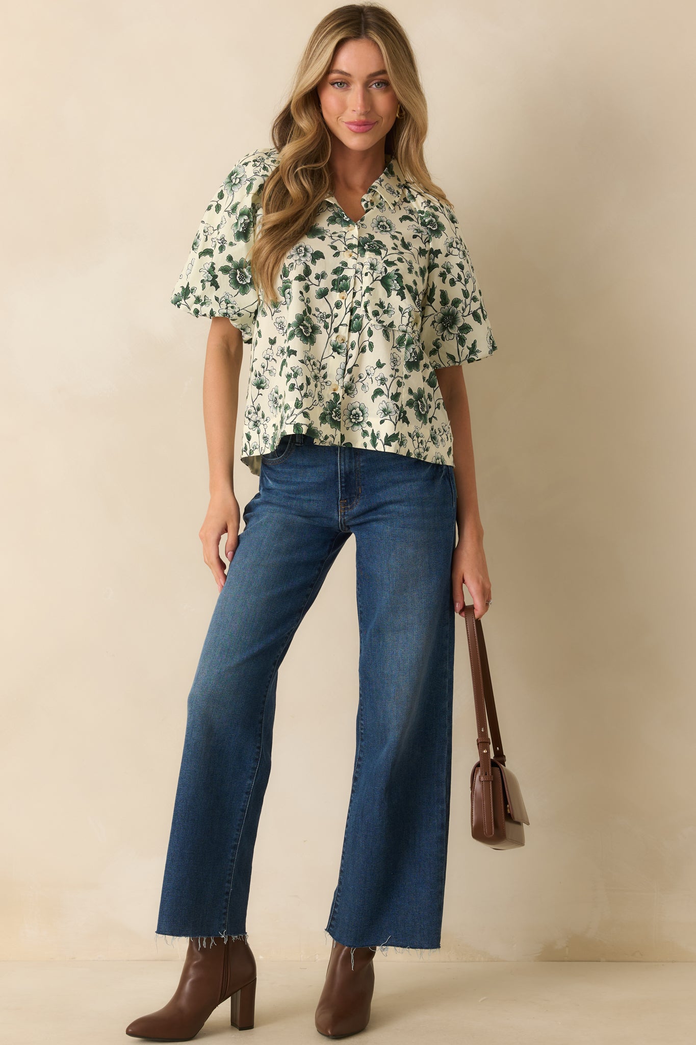 Green print blouse with short puff sleeves and structured collar detailing.