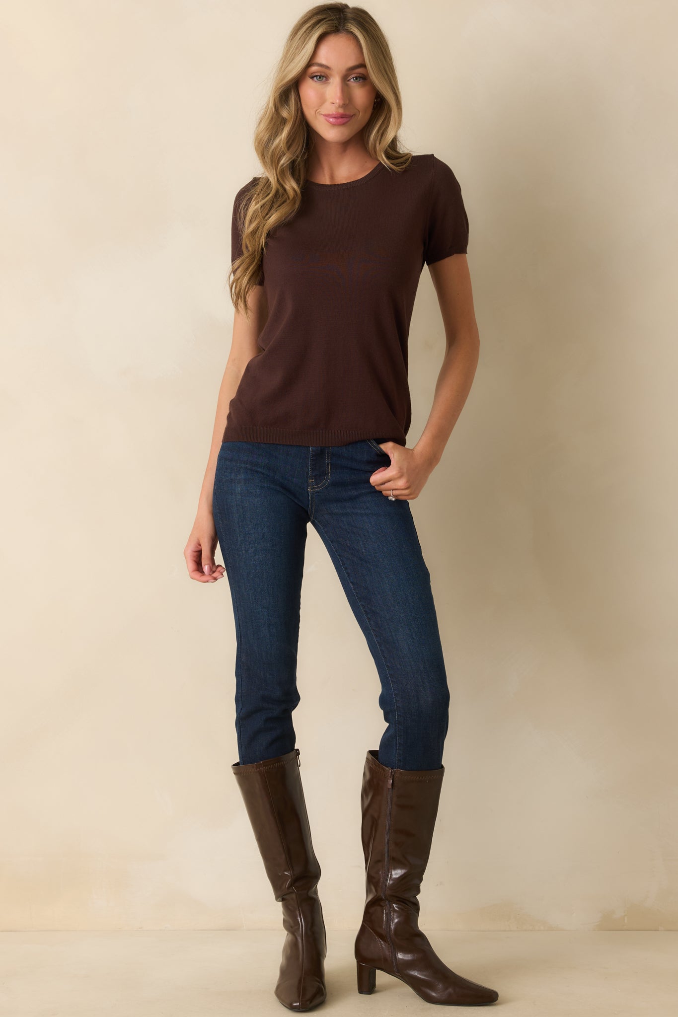 A full front view of the dark brown sweater top with a rounded neckline and short sleeves.