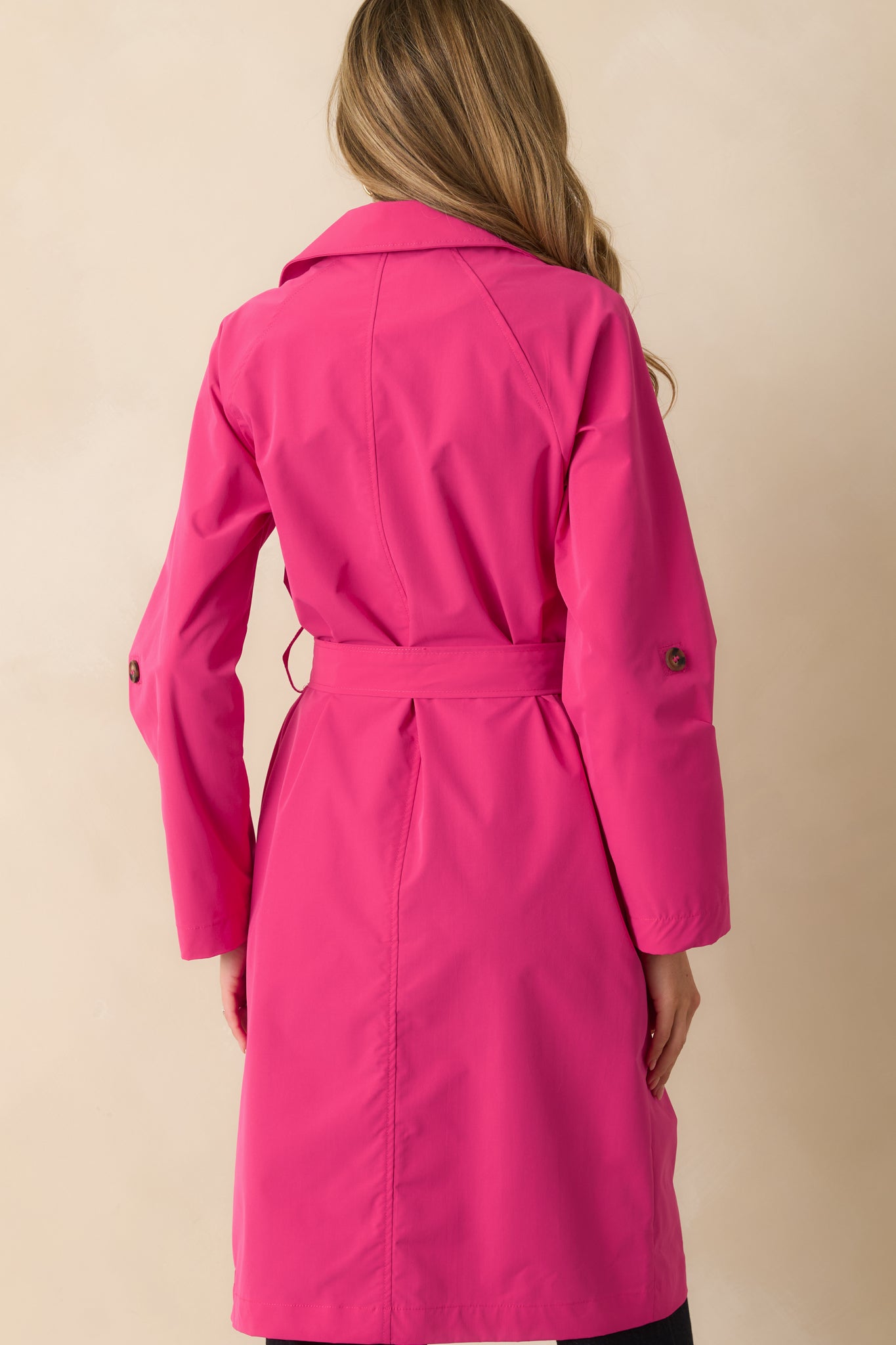Back view of the coat showing the collared neckline, long sleeves, and smooth back silhouette.