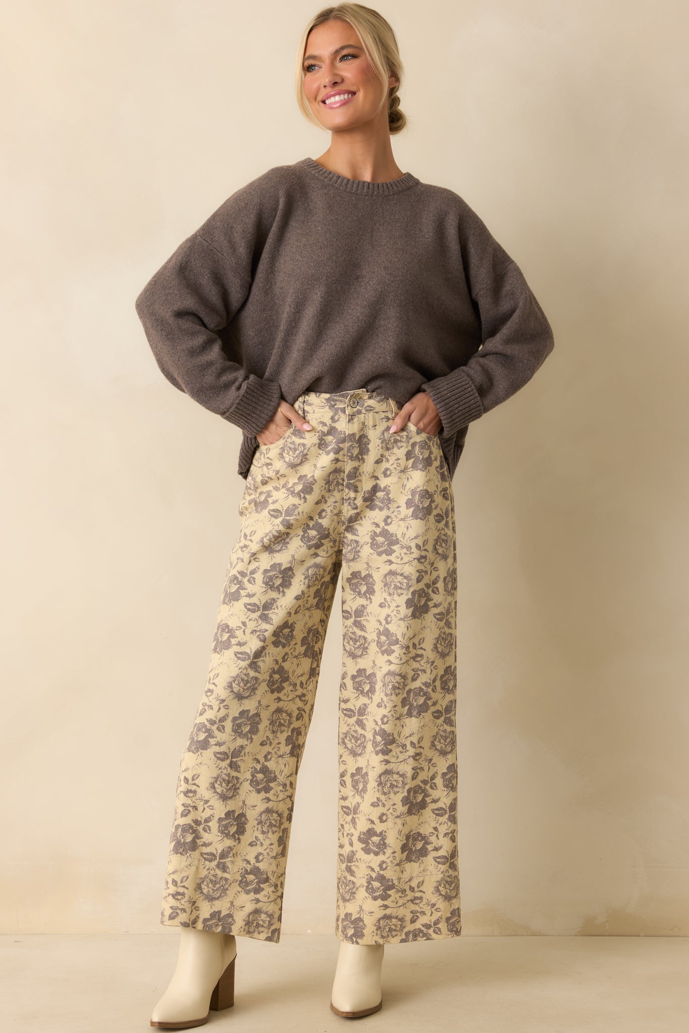 Ash grey sweater with a crew neckline and long sleeves, highlighting its soft fuzzy knit and relaxed fit.