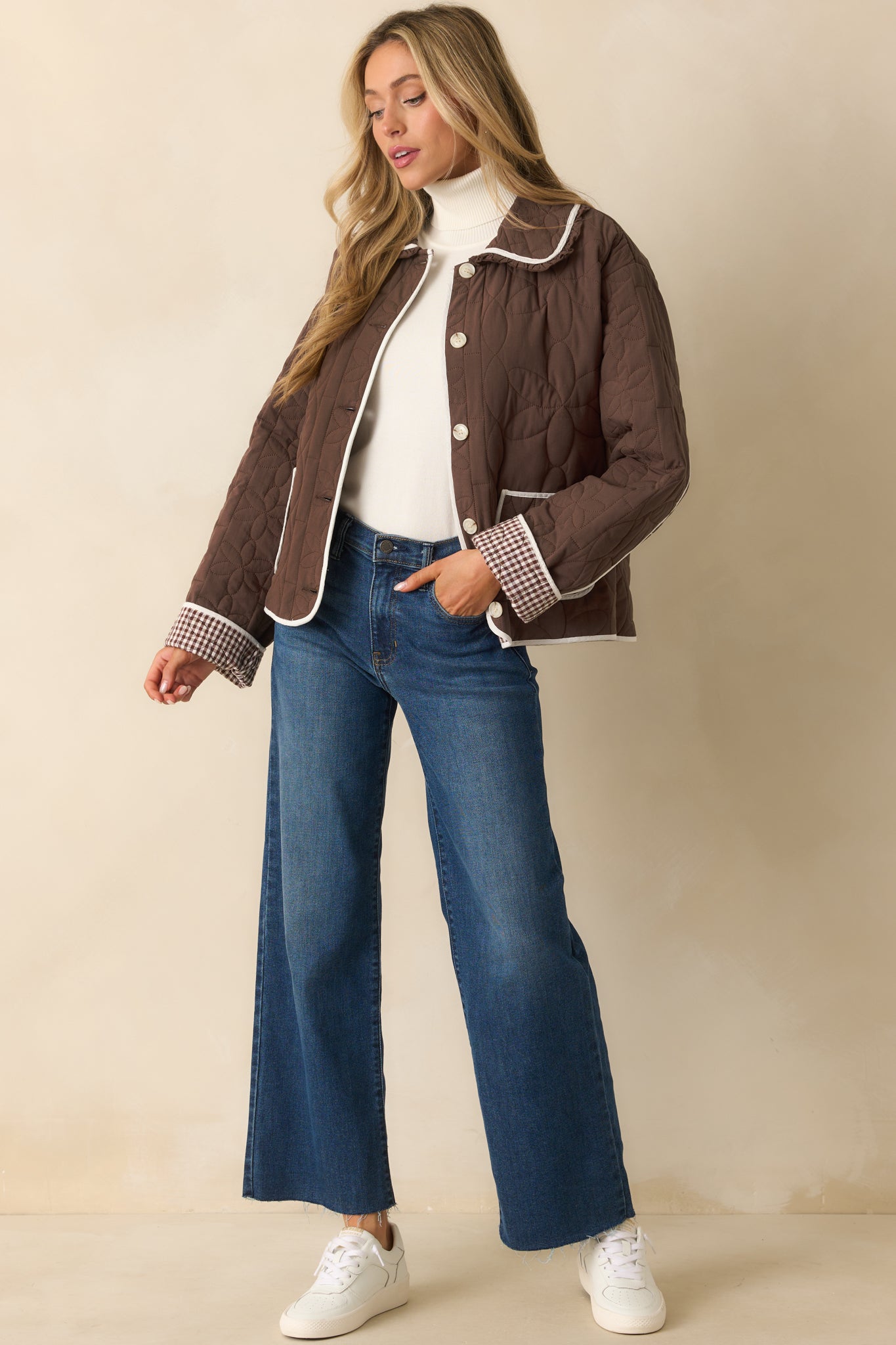 Long-sleeve brown jacket featuring ivory contrast trim, functional patch pockets, and a relaxed silhouette.