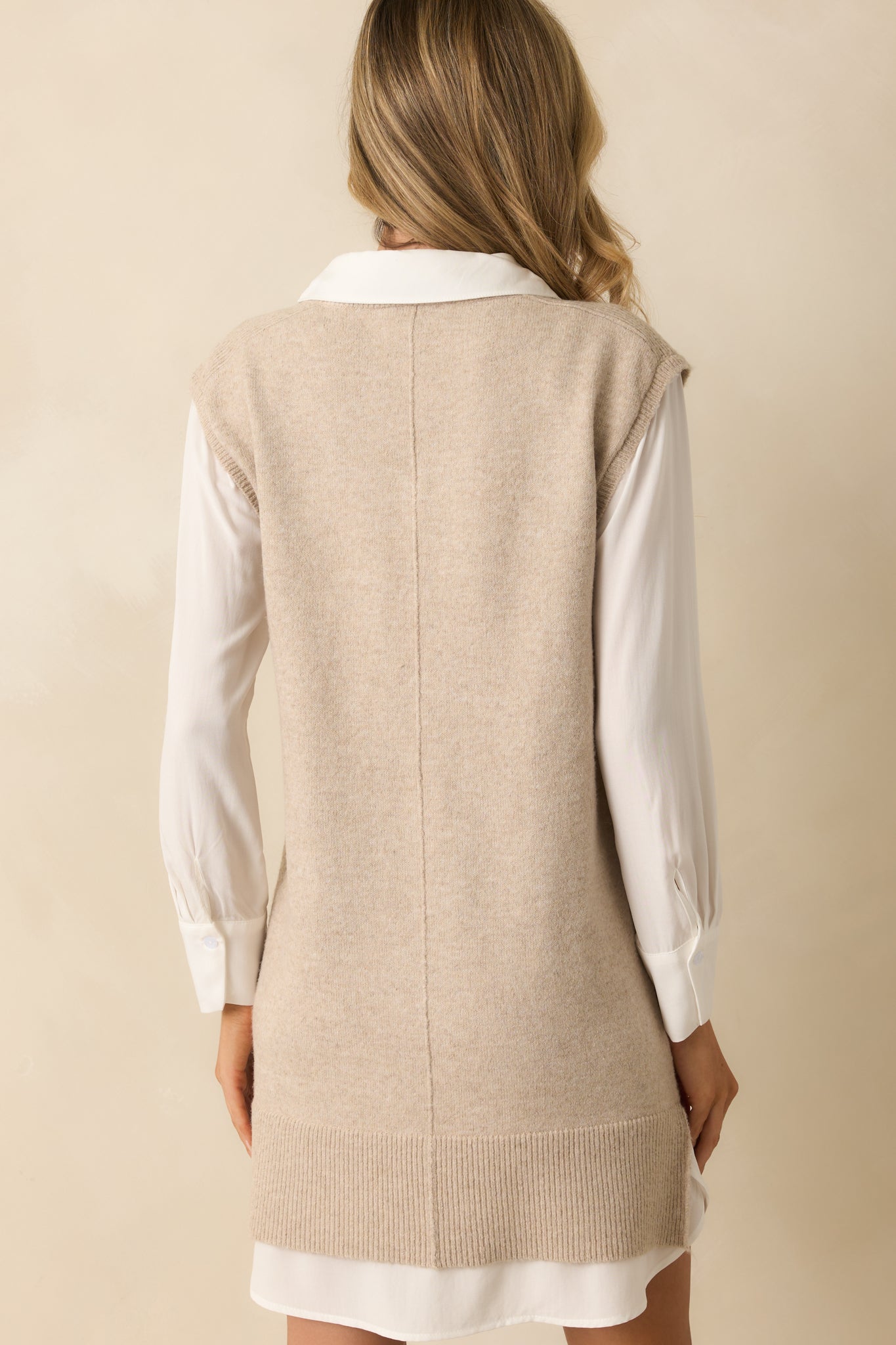 Rear view of the mini dress showing the soft knit fabric and relaxed vest silhouette.
