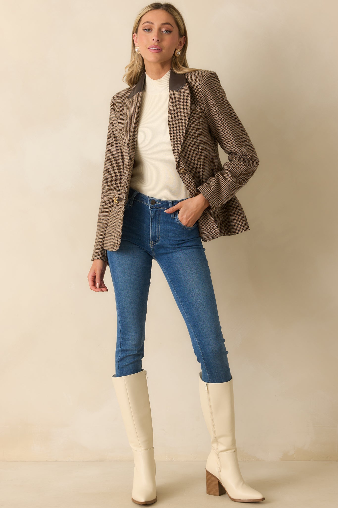 Brown houndstooth blazer with a notched faux leather collar, single-breasted button front, and straight hemline.