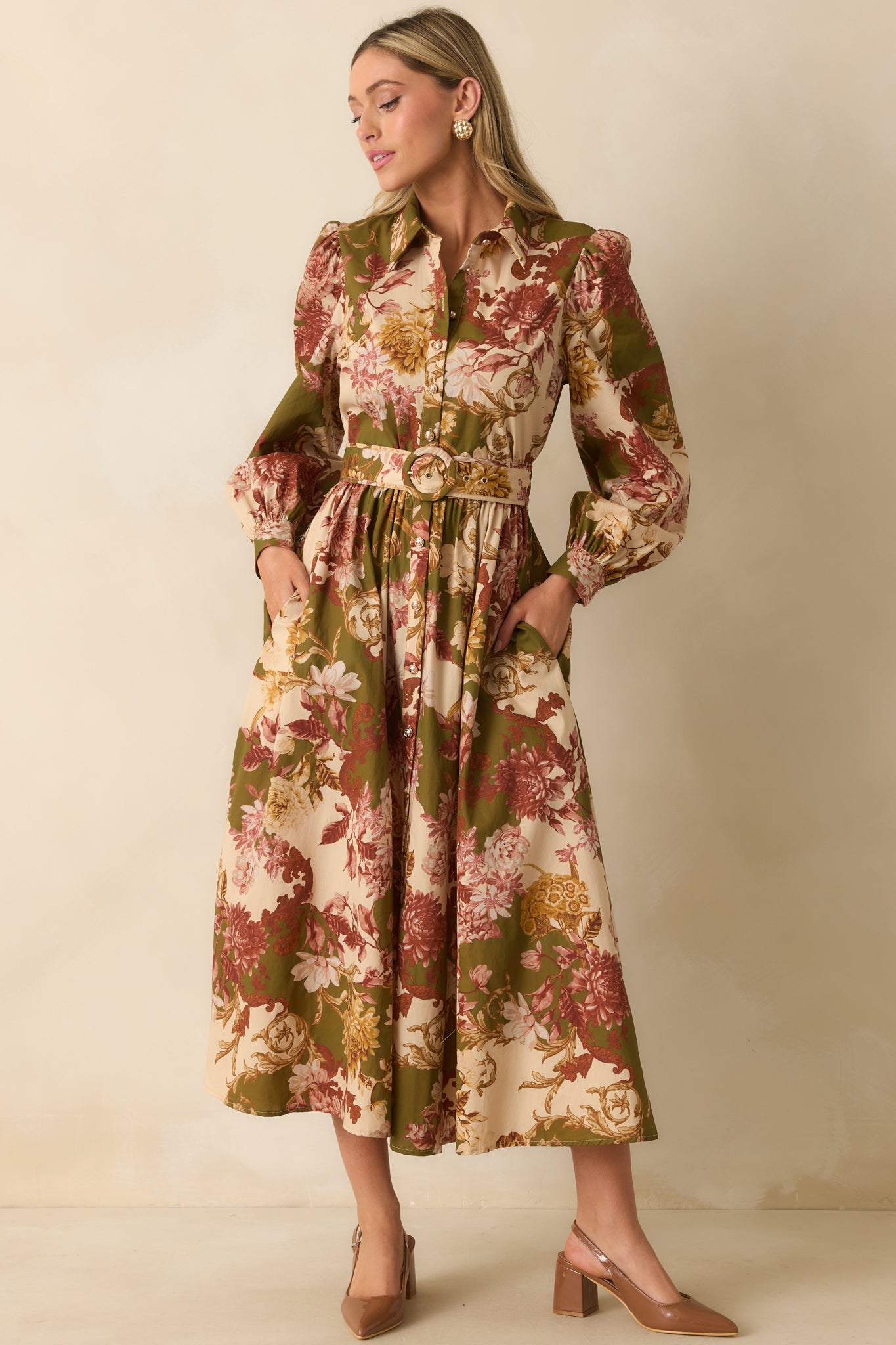 Front view of a floral olive green dress featuring a collared neckline, buttoned puff sleeves, and pockets, with relaxed fit.