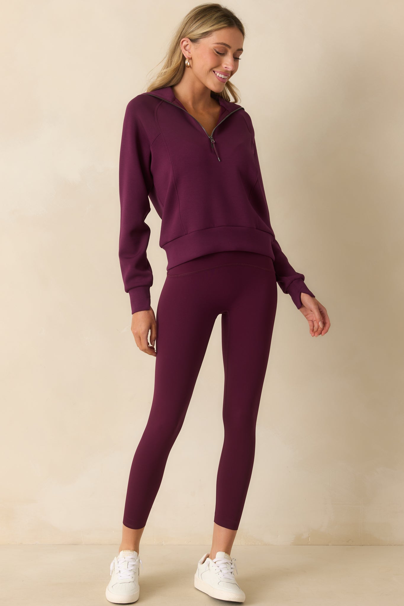 Full body angle highlighting the half-zip closure and fine knit structure of the plum berry pullover.