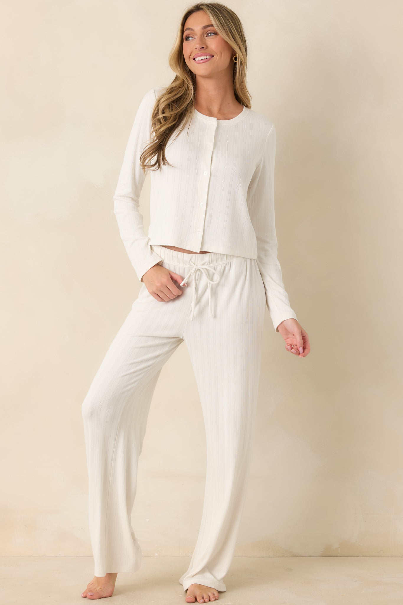 Ivory lounge pants featuring a relaxed straight-leg silhouette and elastic drawstring waistband.