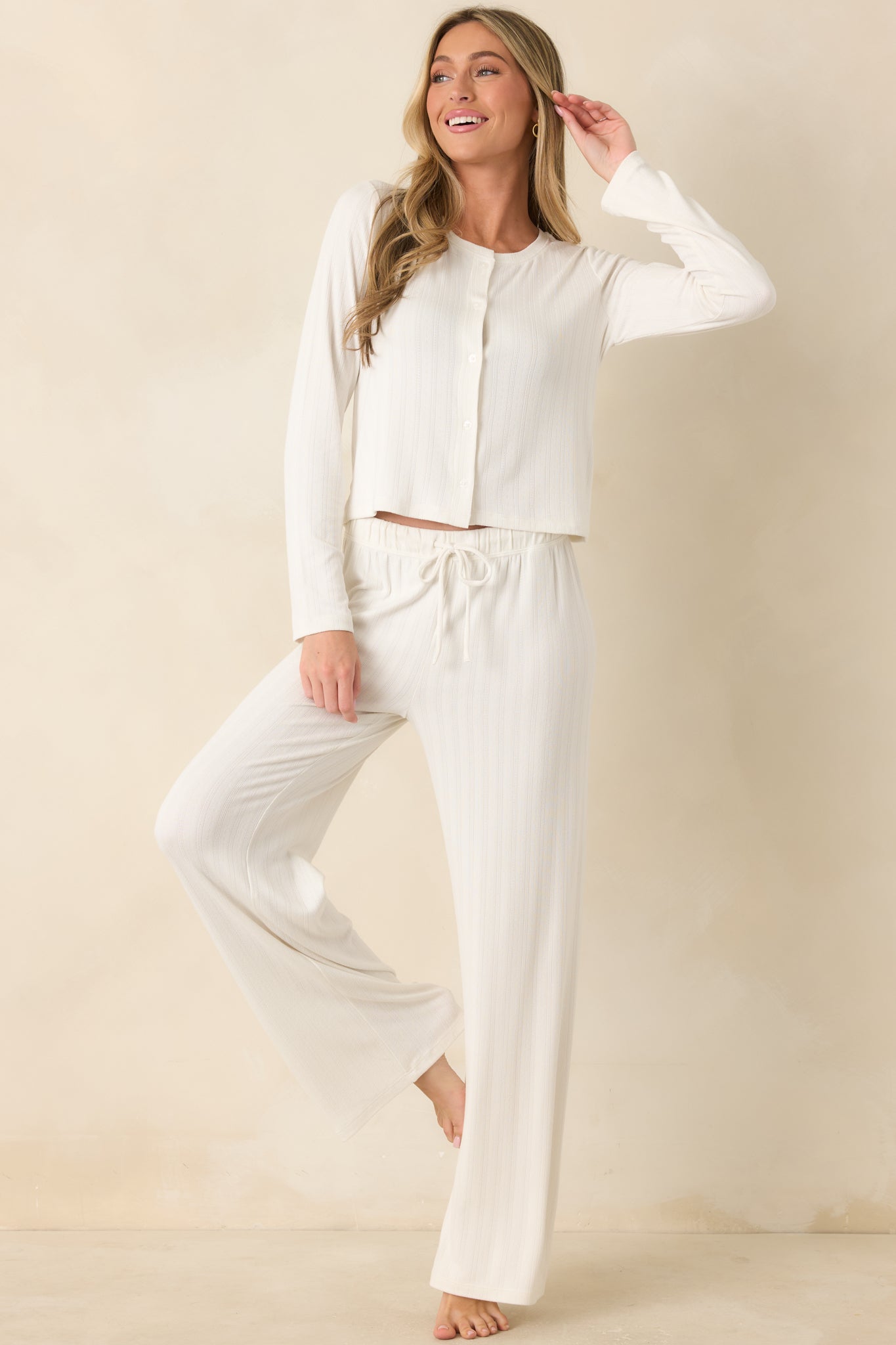 Ivory button-front knit top showcasing a relaxed fit and breathable openwork fabric design.