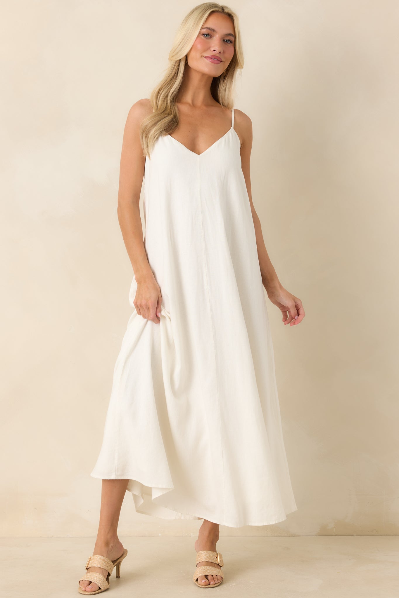 White spaghetti strap midi dress showcasing a breezy fit and simple minimalist design.