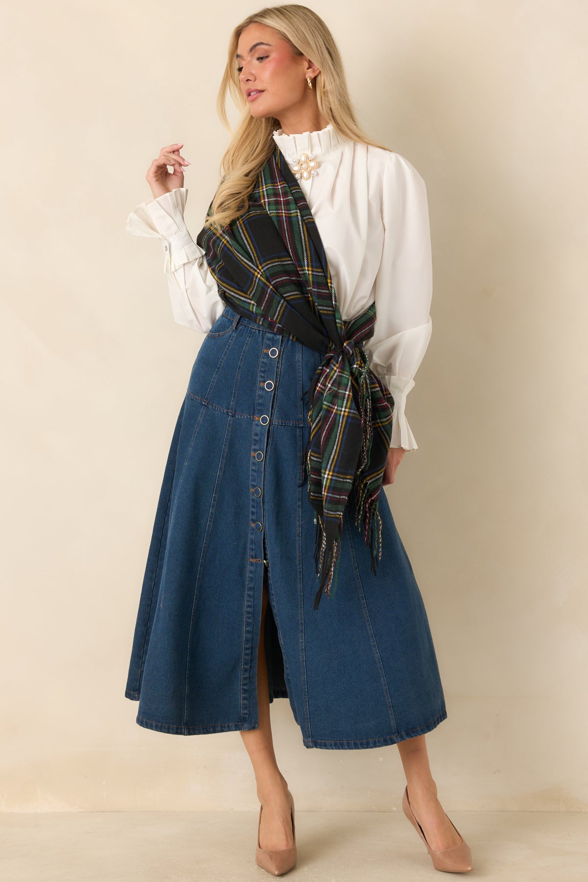 A-line denim midi skirt with curved front pockets, belt loops, and warm contrast stitching.